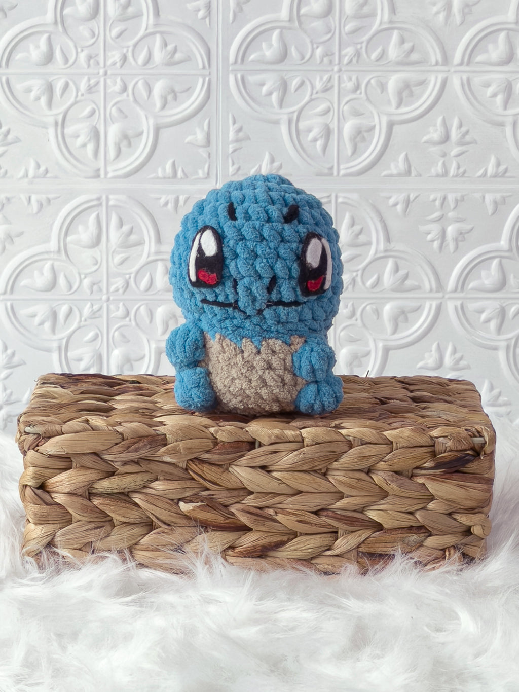 Handmade blue, light squirtle crochet plushie shown from the front