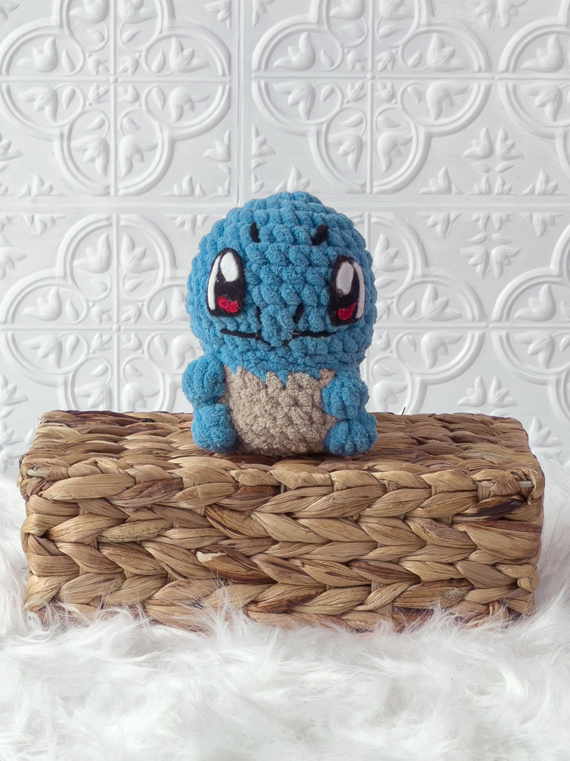 Handmade blue, light squirtle crochet plushie shown from the front