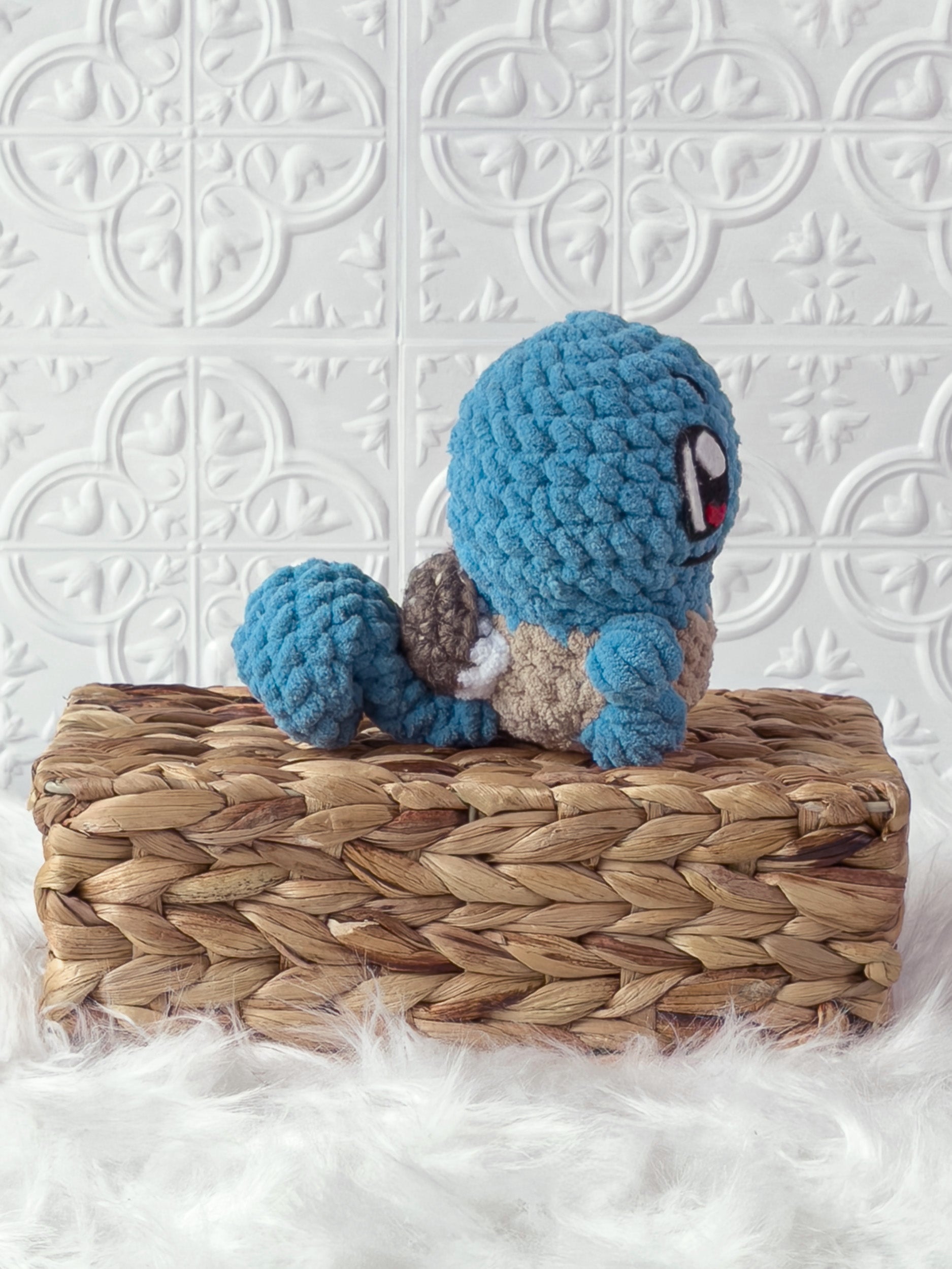 Handmade blue, light squirtle crochet plushie shown from the side