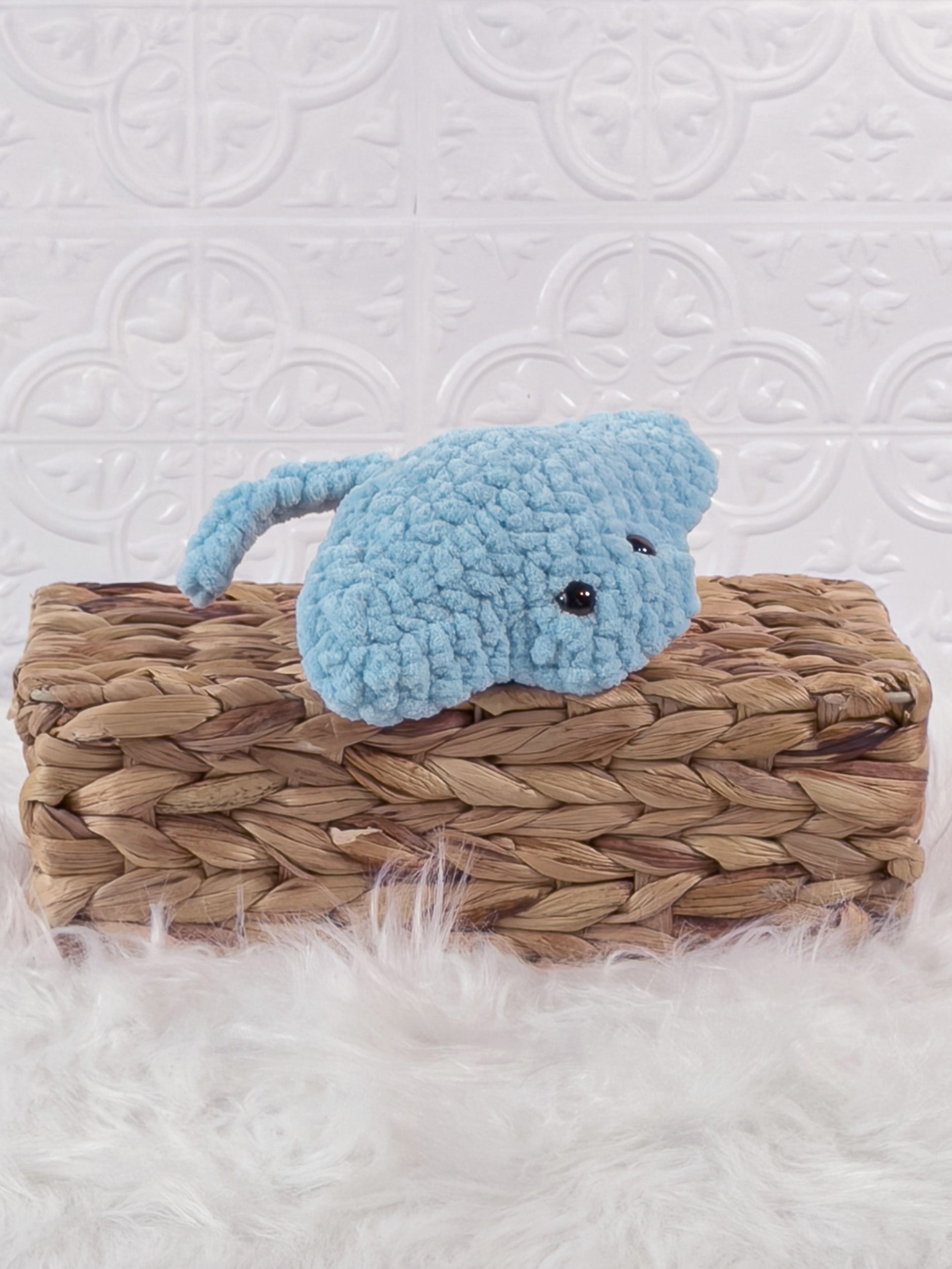 Handmade blue, light stingray crochet plushie shown from an angled view
