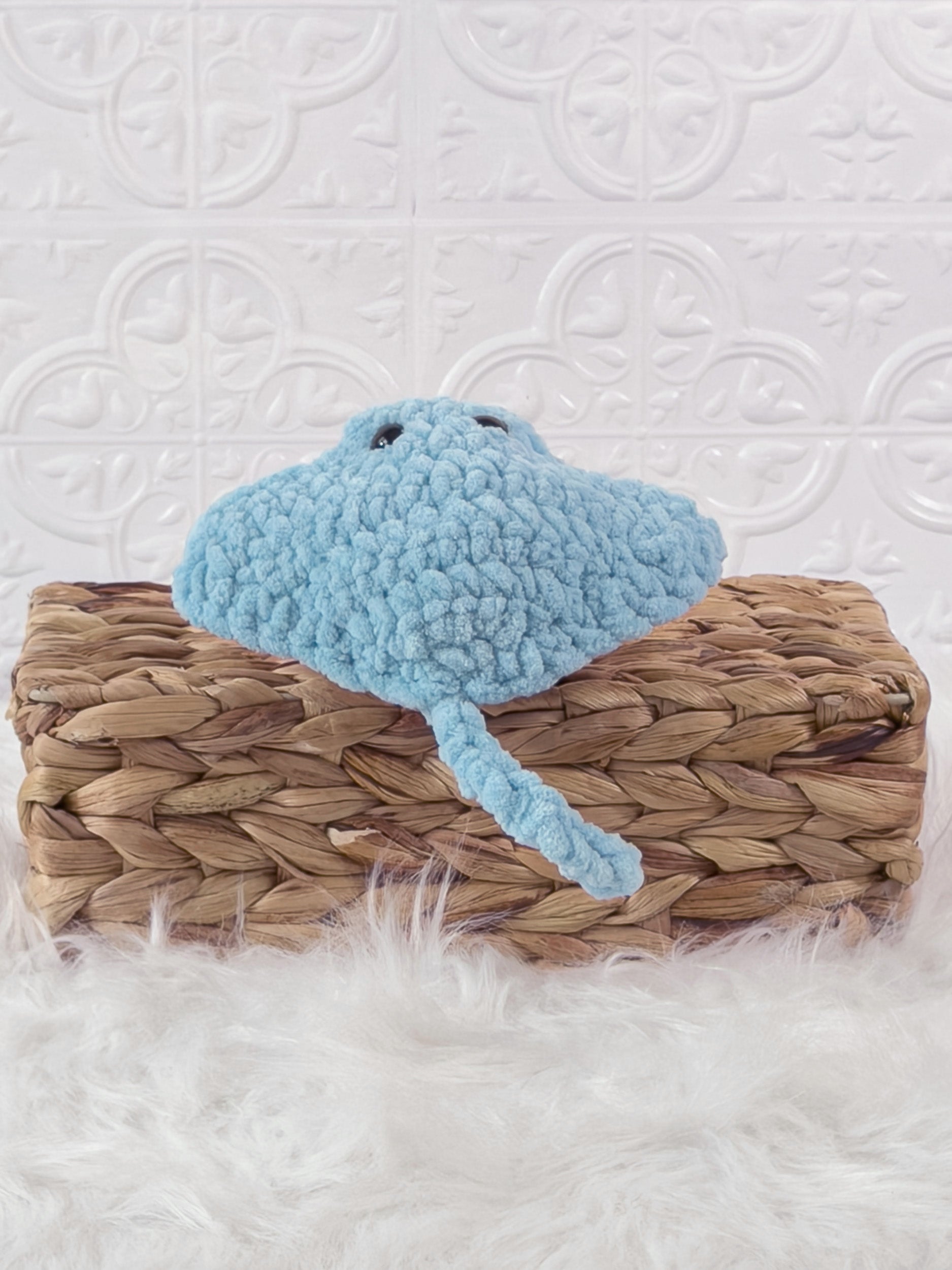 Handmade blue, light stingray crochet plushie shown from the back