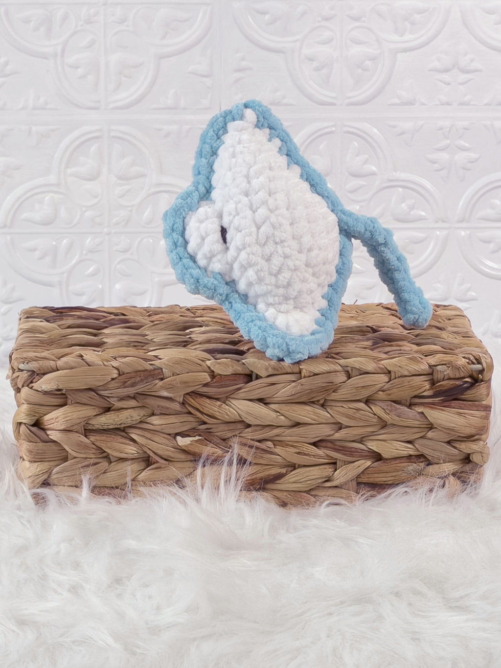 Handmade blue, light stingray crochet plushie shown from the side