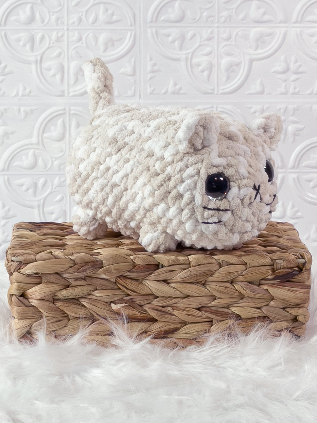 Handmade brown, cream big loaf cat crochet plushie shown from an angled view