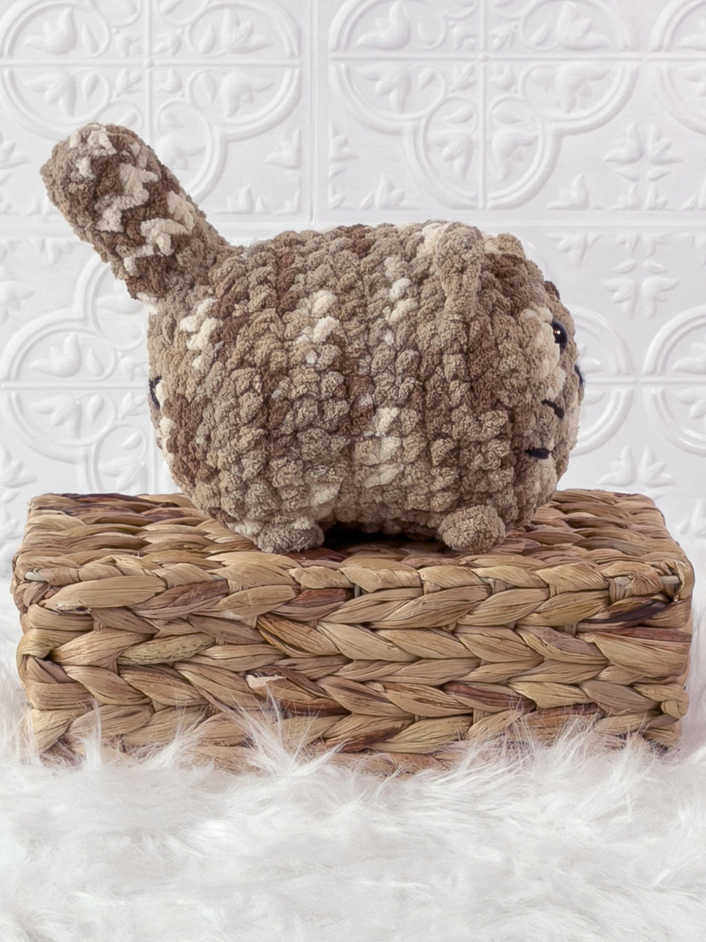 Handmade brown, dark big loaf cat crochet plushie shown from the side