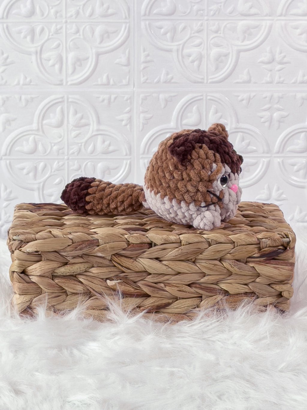 Handmade brown kitten crochet plushie shown from an angled view