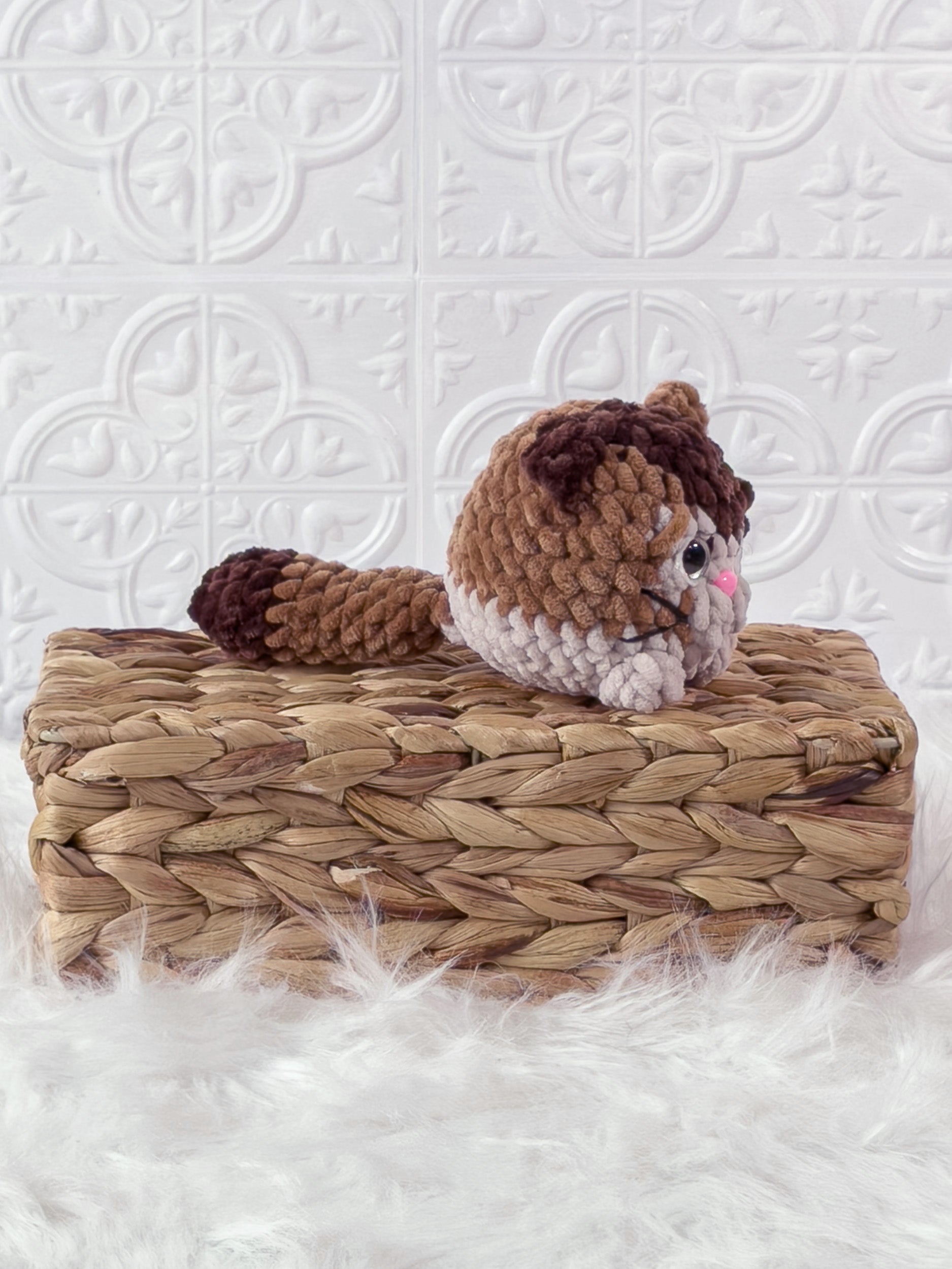Handmade brown kitten crochet plushie shown from an angled view
