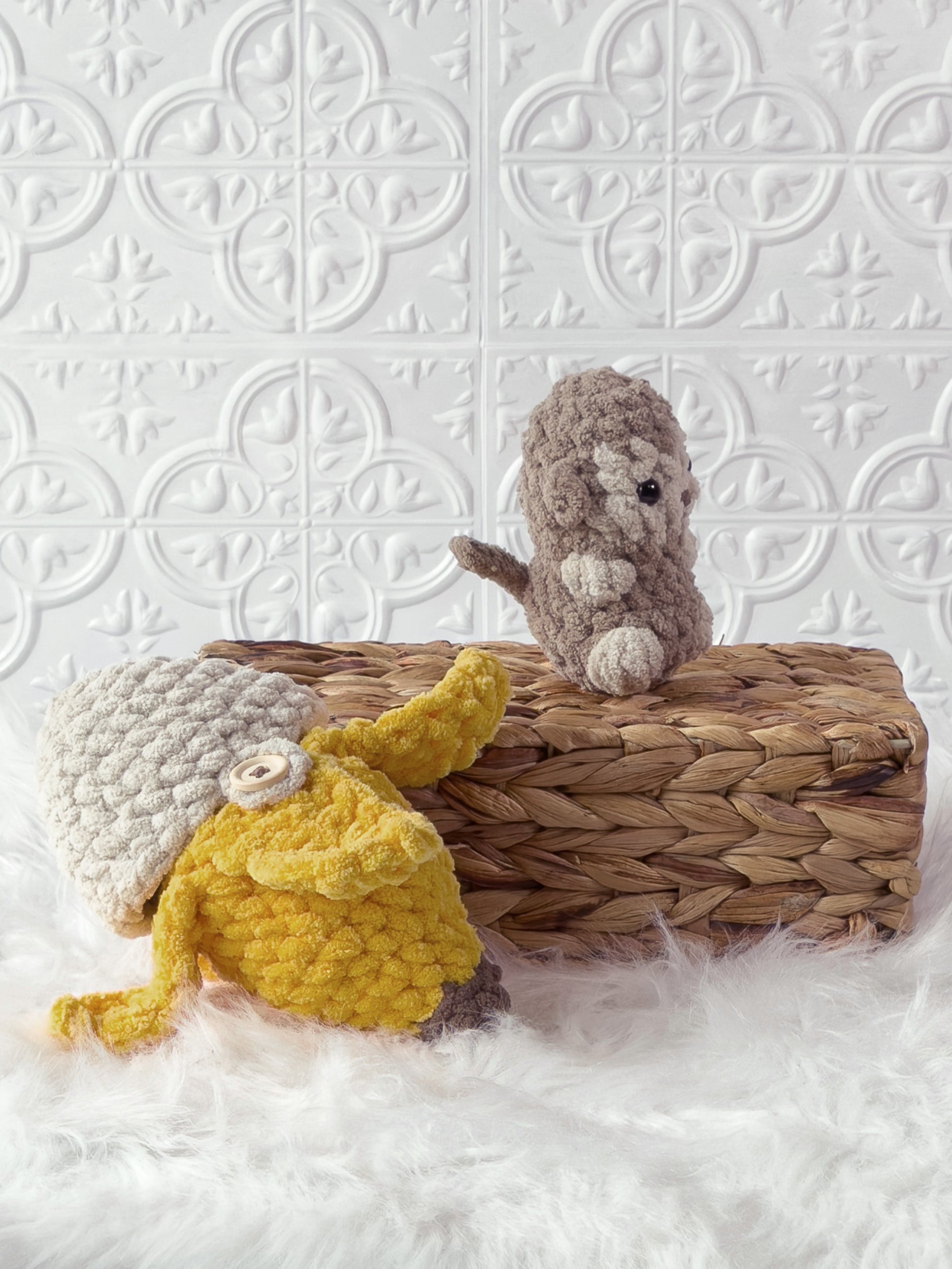 Handmade brown, yellow peek a boo monkey in banana crochet plushie shown from an angled view