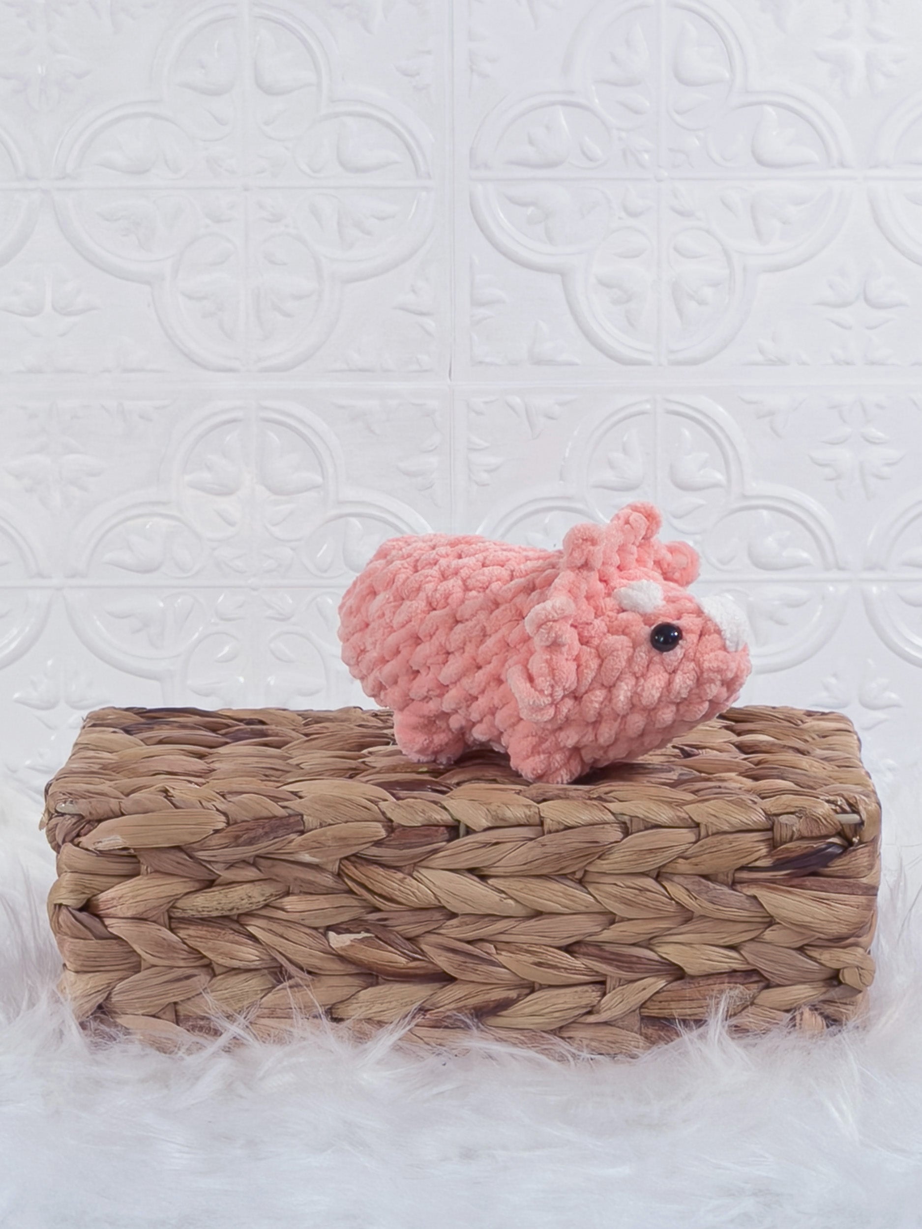 Handmade triceratops crochet plushie shown from the front