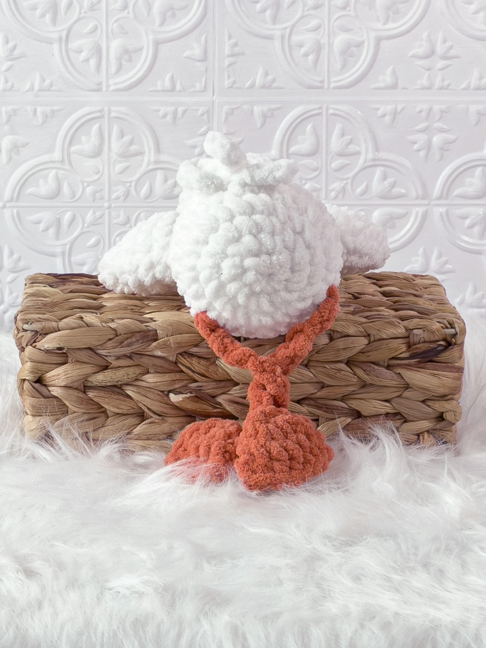 Handmade cream, orange silly goose crochet plushie shown from the back