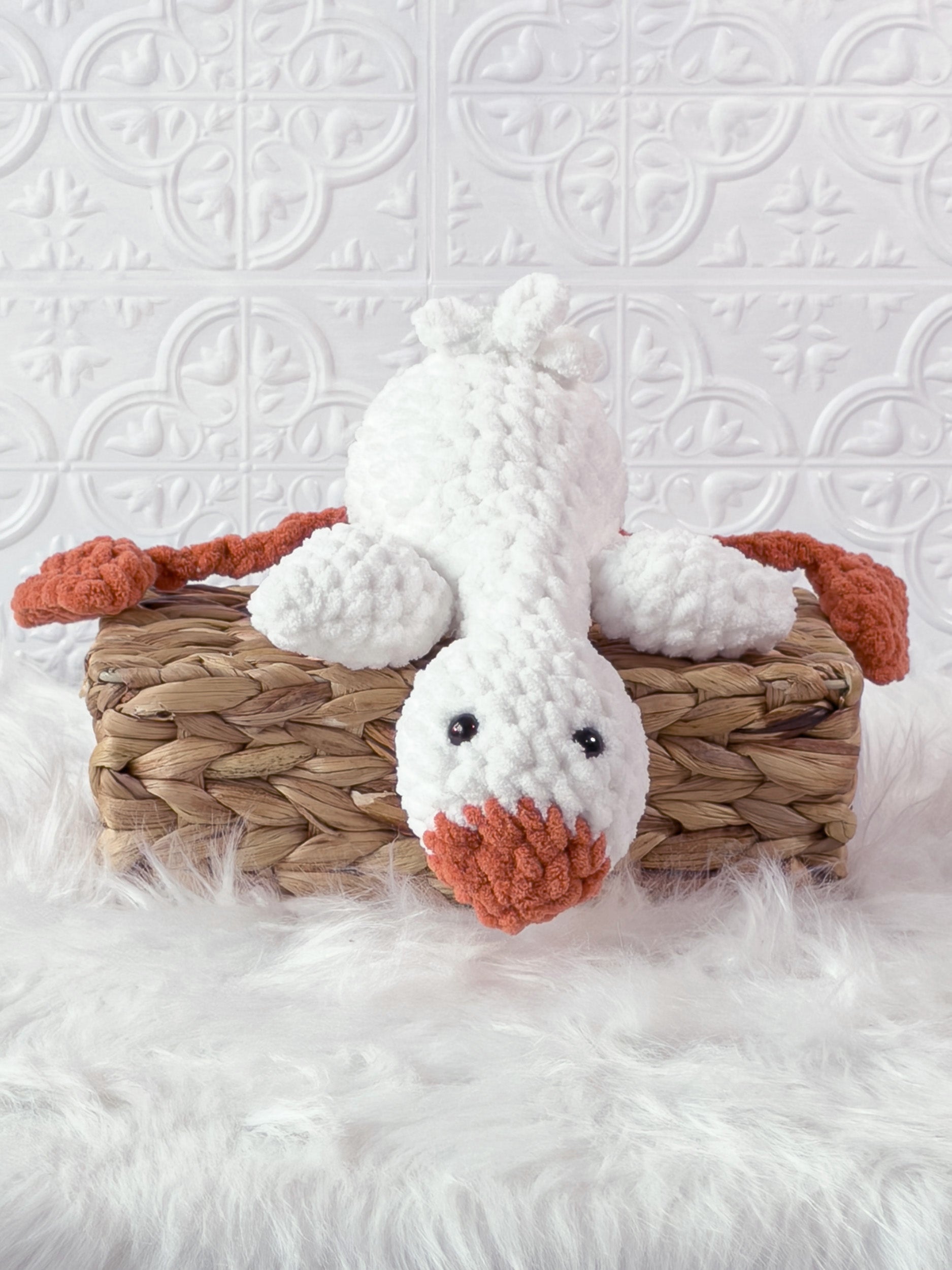 Handmade cream, orange silly goose crochet plushie shown from the front
