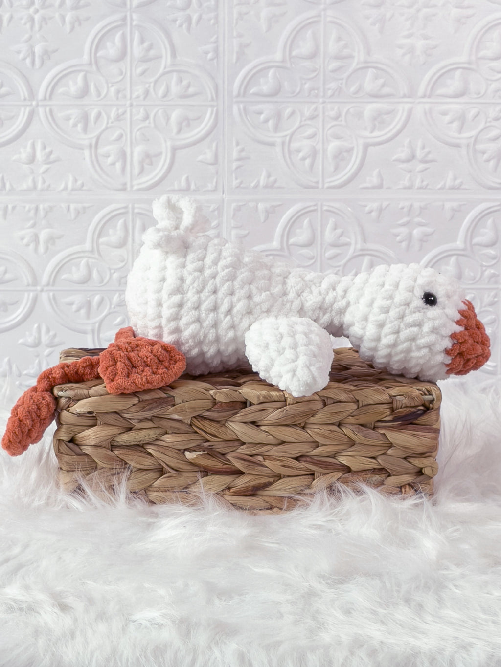 Handmade cream, orange silly goose crochet plushie shown from the side