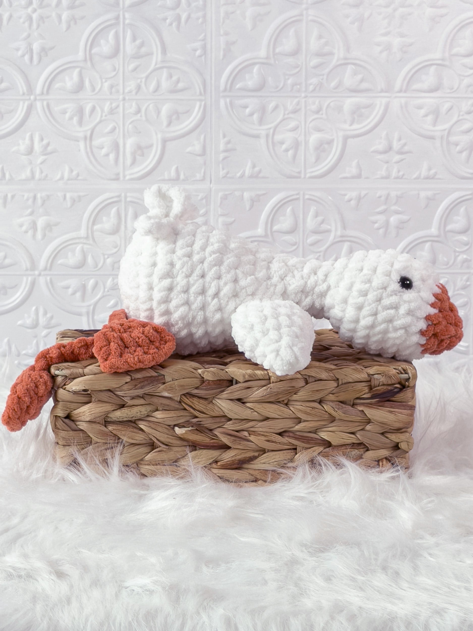 Handmade cream, orange silly goose crochet plushie shown from the side