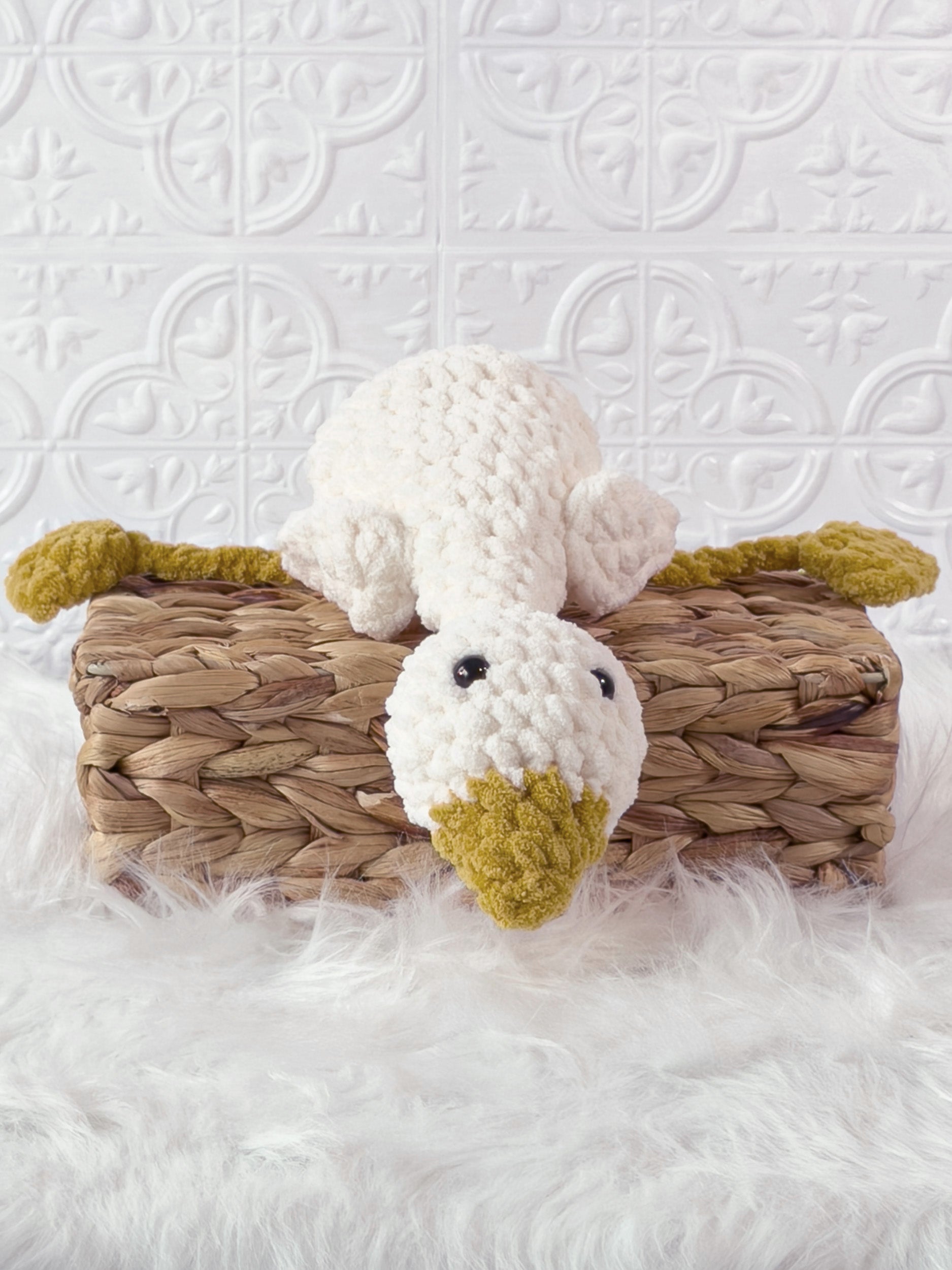 Handmade cream, yellow silly goose crochet plushie shown from the front