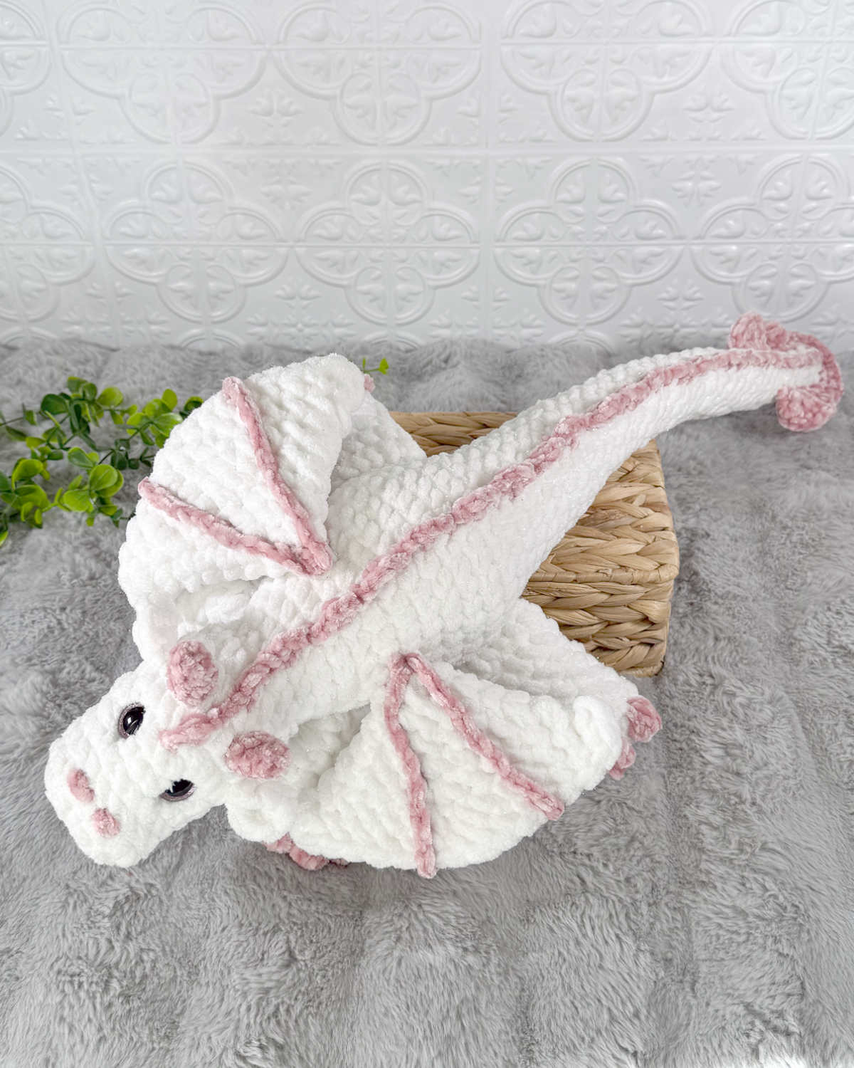 Handmade white dragon crochet plushie shown from an angled view