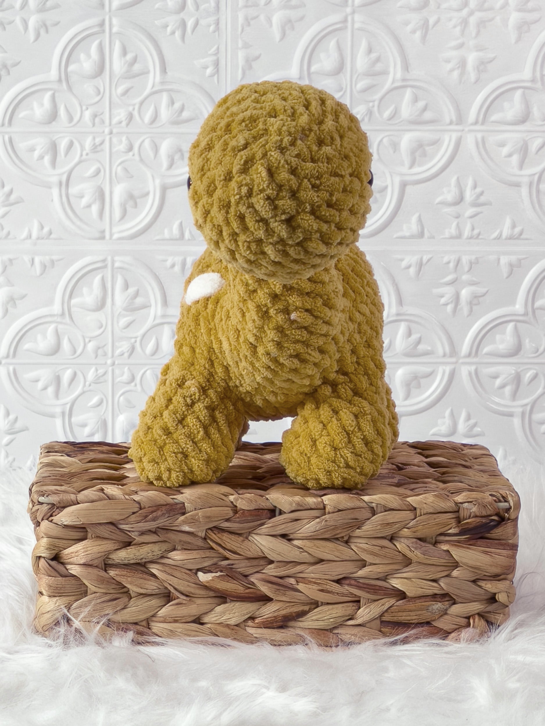 Handmade gold brachiosaurus crochet plushie shown from the front