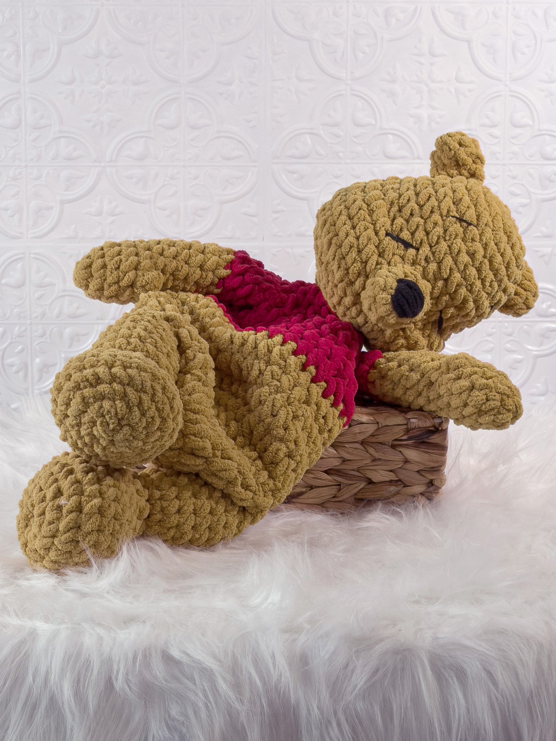 Handmade gold winnie the pooh crochet snuggler shown from an angled view