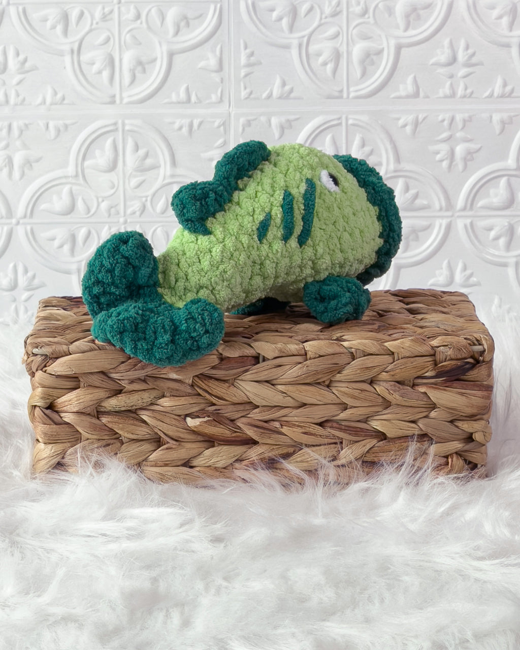 Handmade green bass fish crochet plushie shown from an angled view