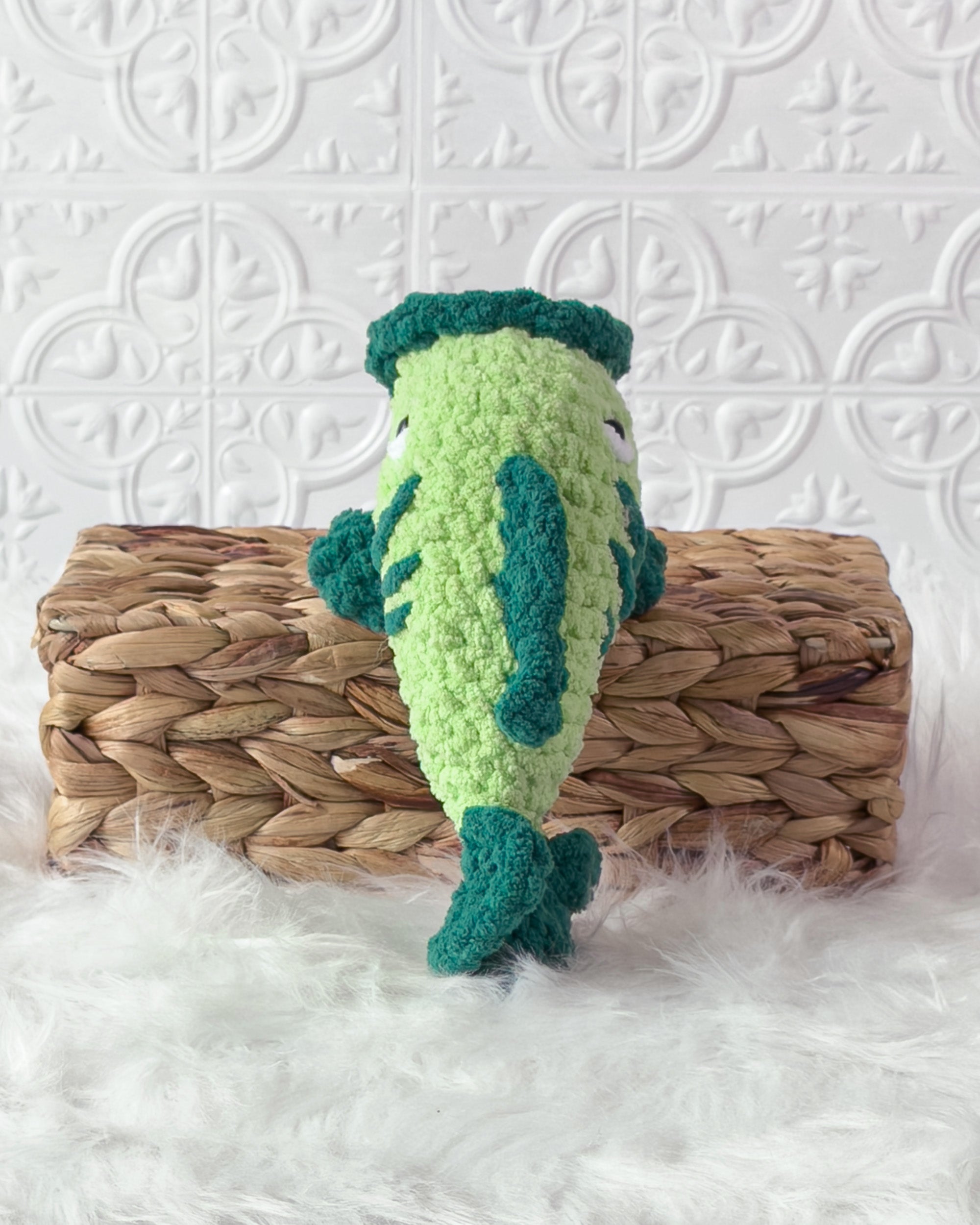 Handmade green bass fish crochet plushie shown from the back