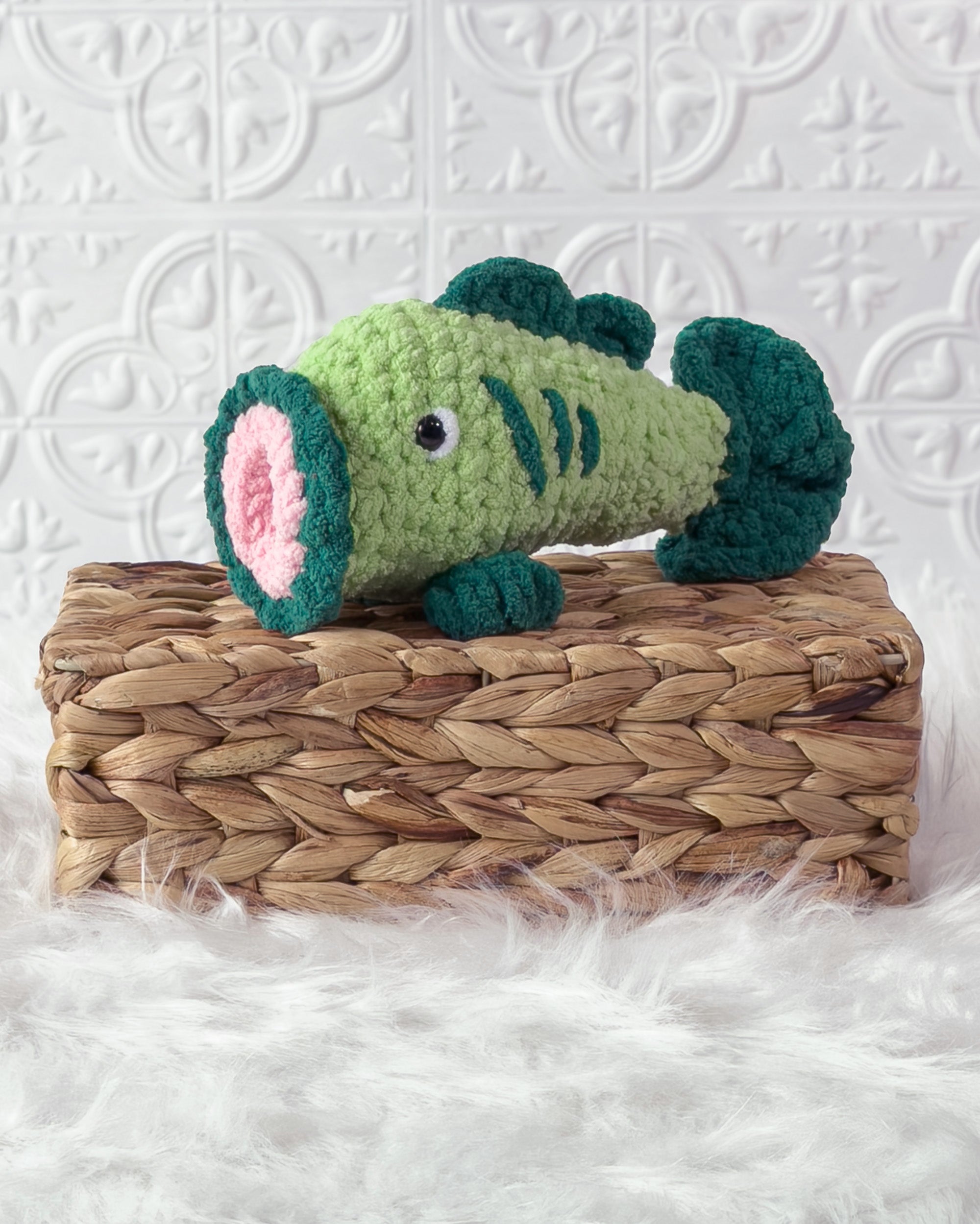 Handmade bass fish crochet plushie shown from the front