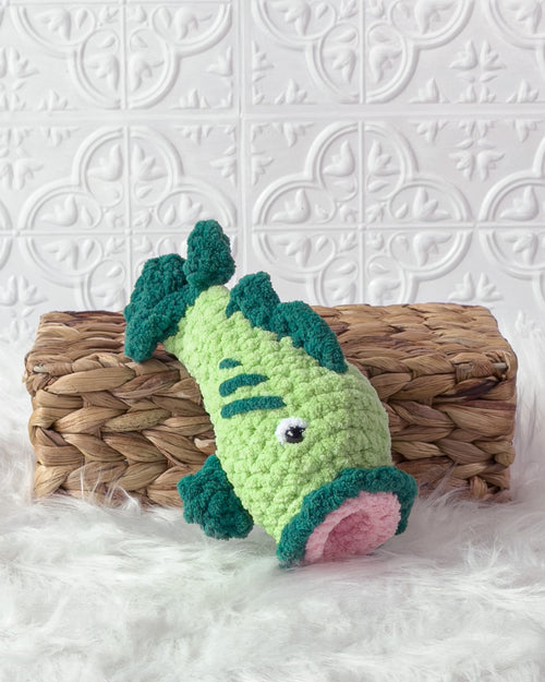 Handmade green bass fish crochet plushie shown from the front