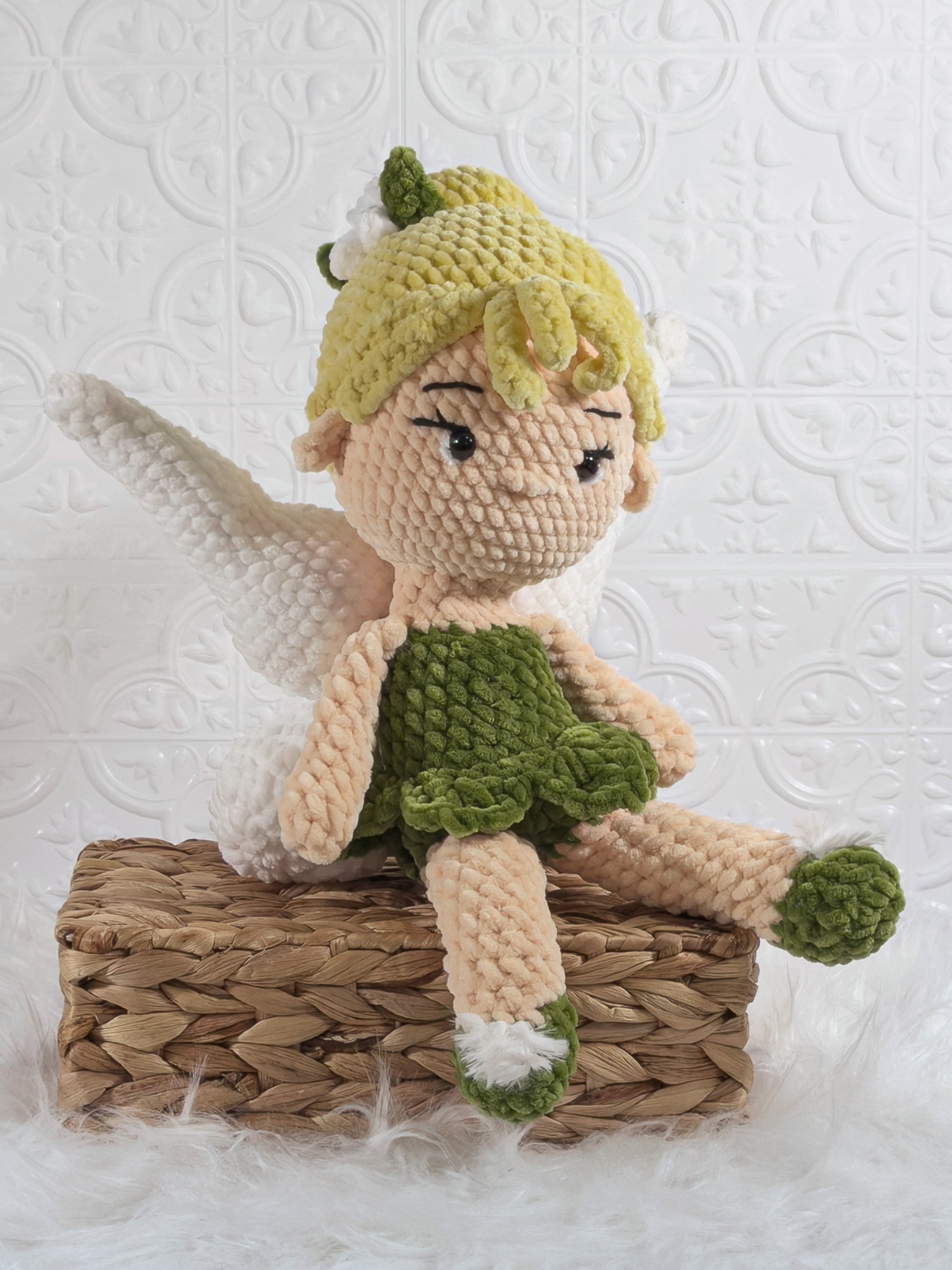 Handmade green fairy crochet plushie shown from an angled view