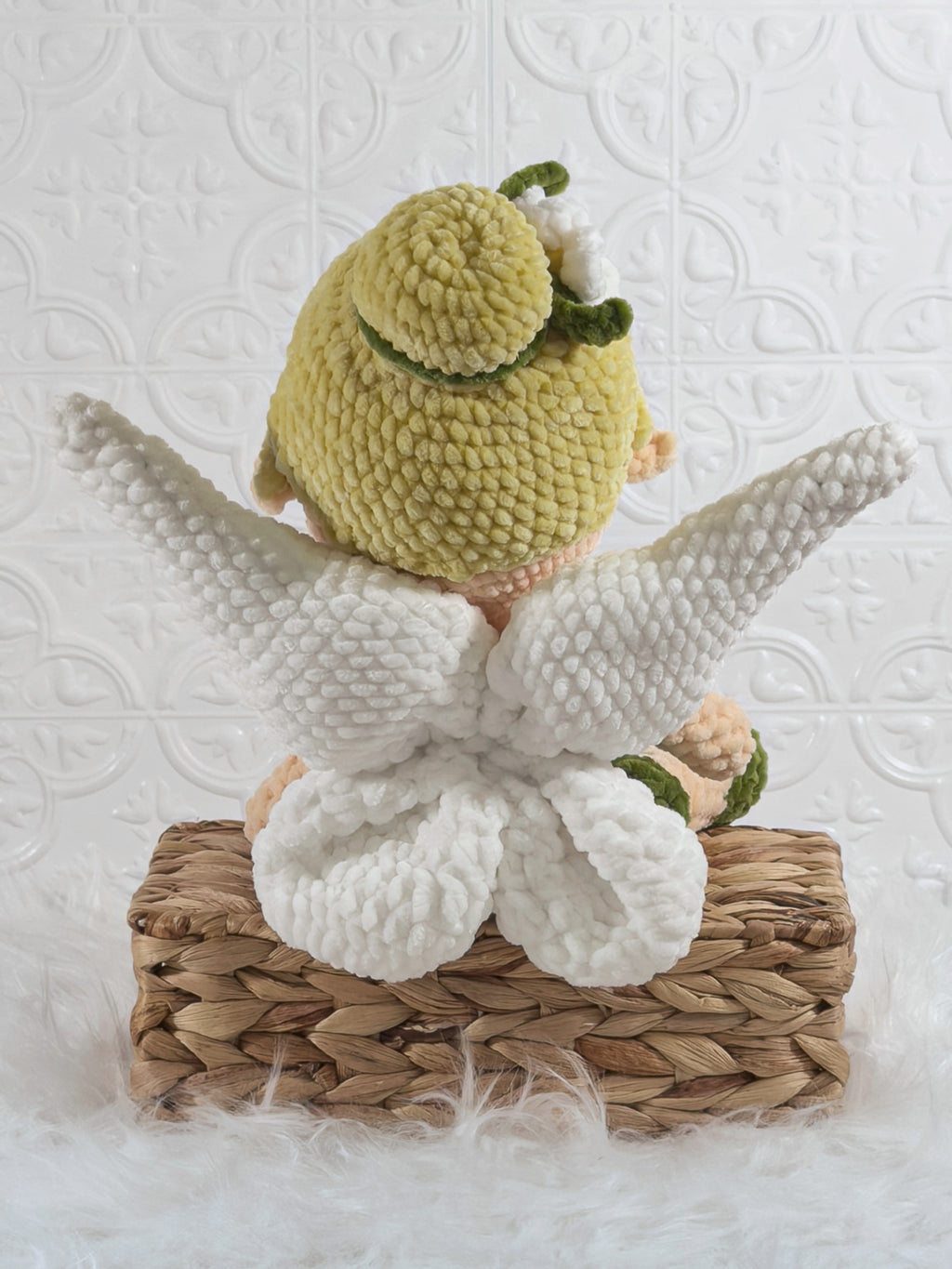 Handmade green fairy crochet plushie shown from the back