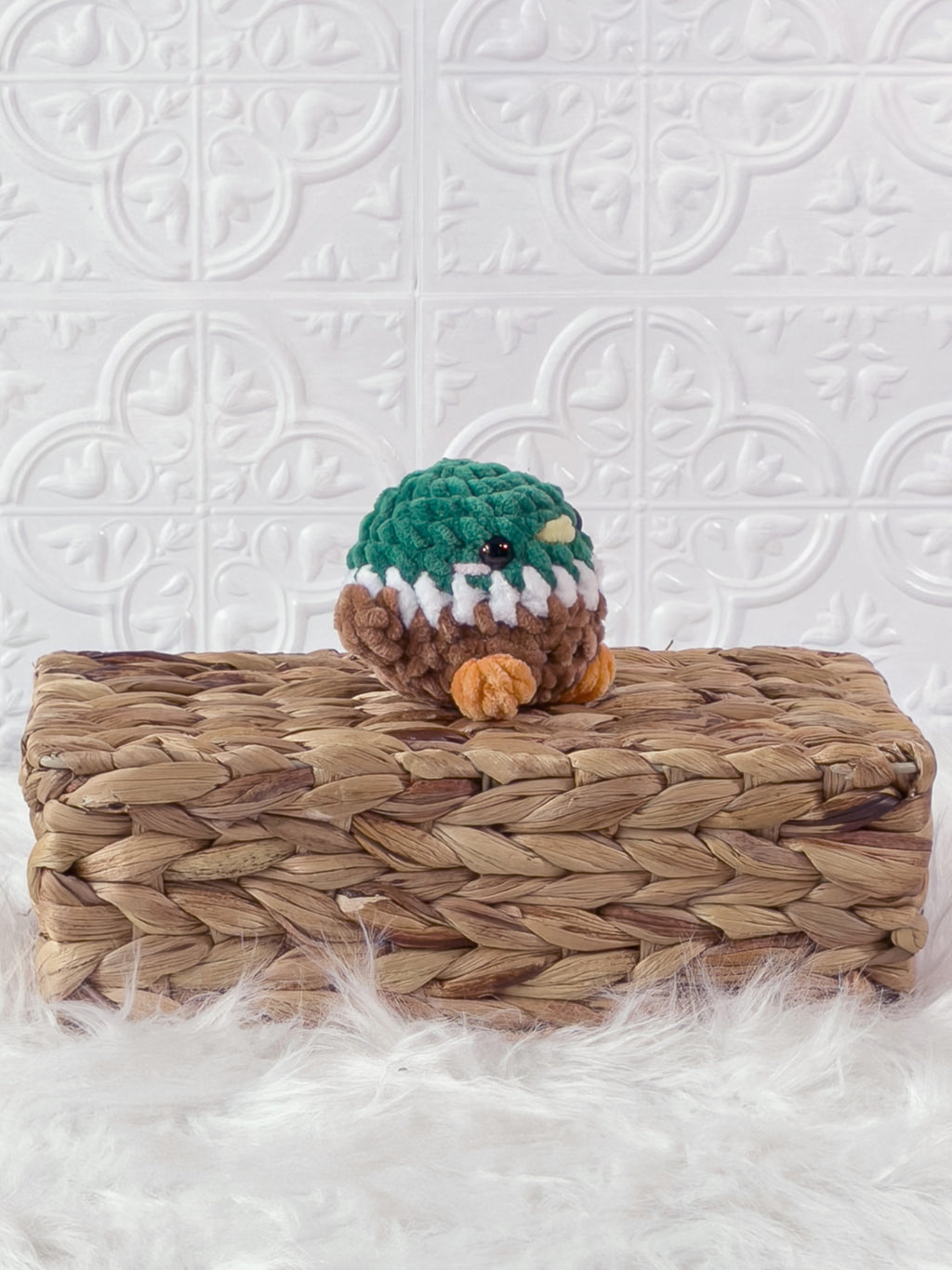 Handmade green mallard crochet plushie shown from an angled view