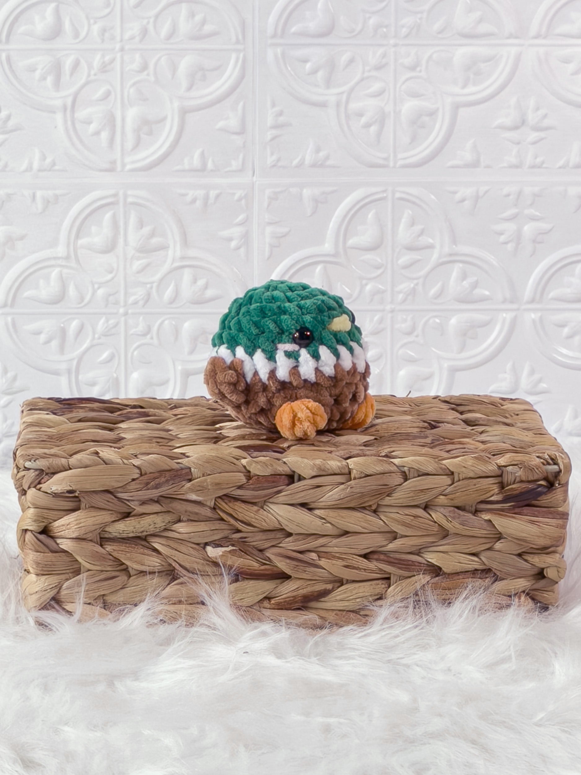 Handmade green mallard crochet plushie shown from an angled view