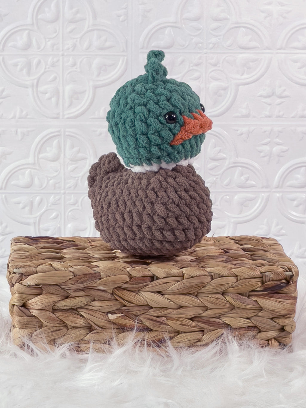 Handmade green mallard rubber duck crochet plushie shown from an angled view