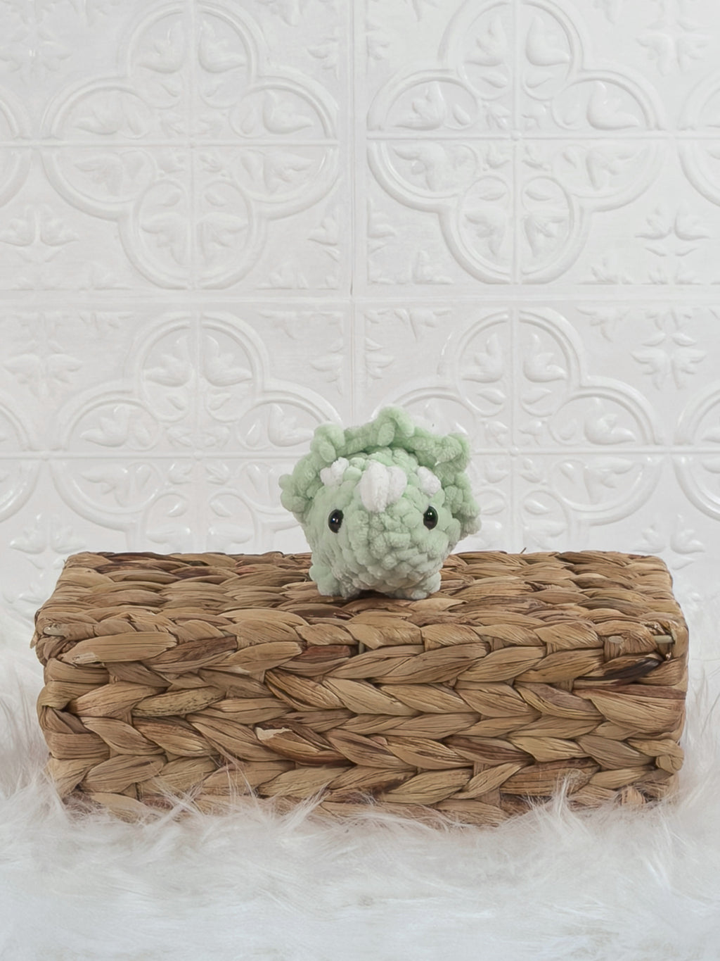 Handmade green triceratops crochet plushie shown from the front