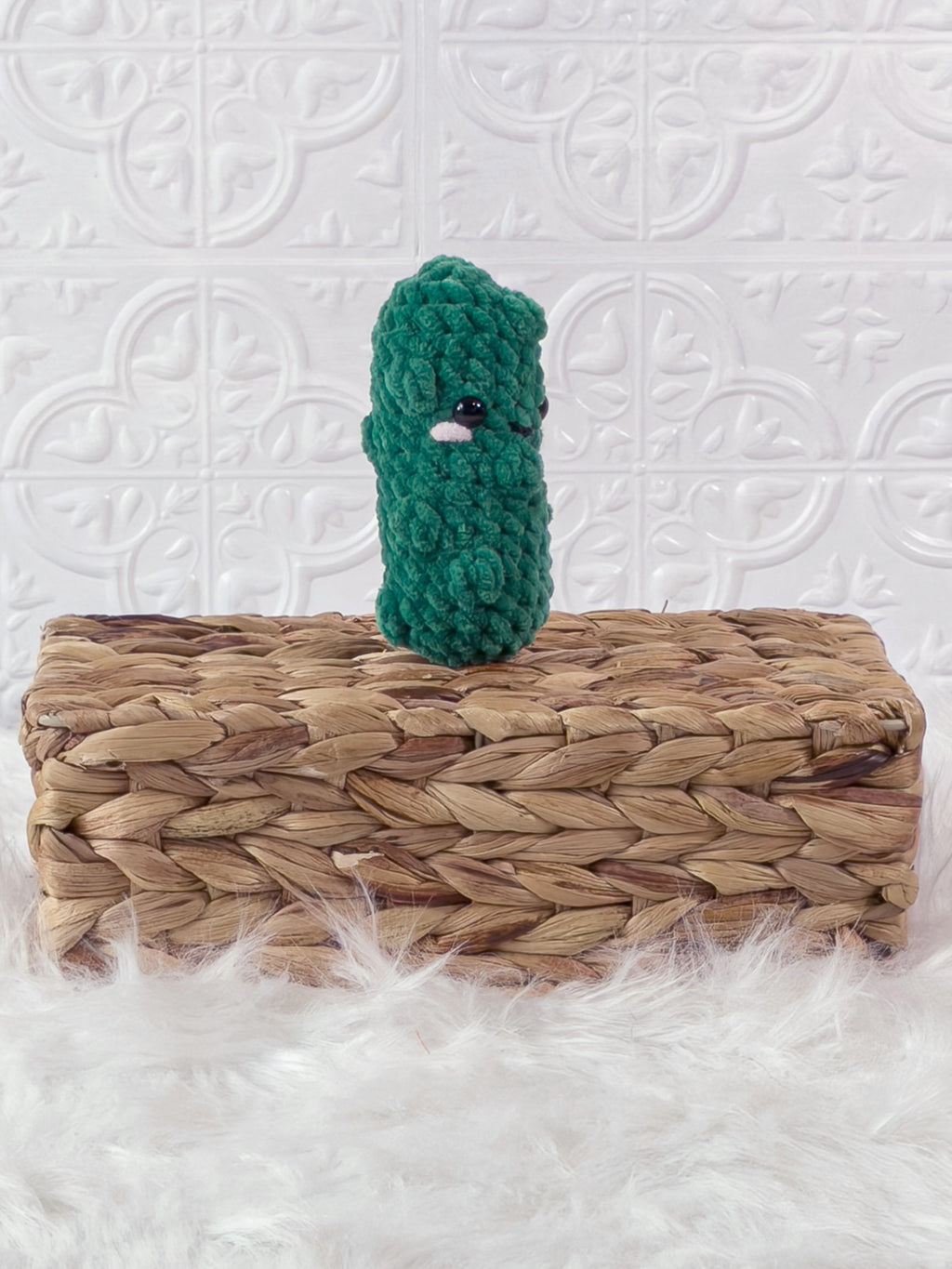 Handmade green, dark dill pickle crochet plushie shown from an angled view