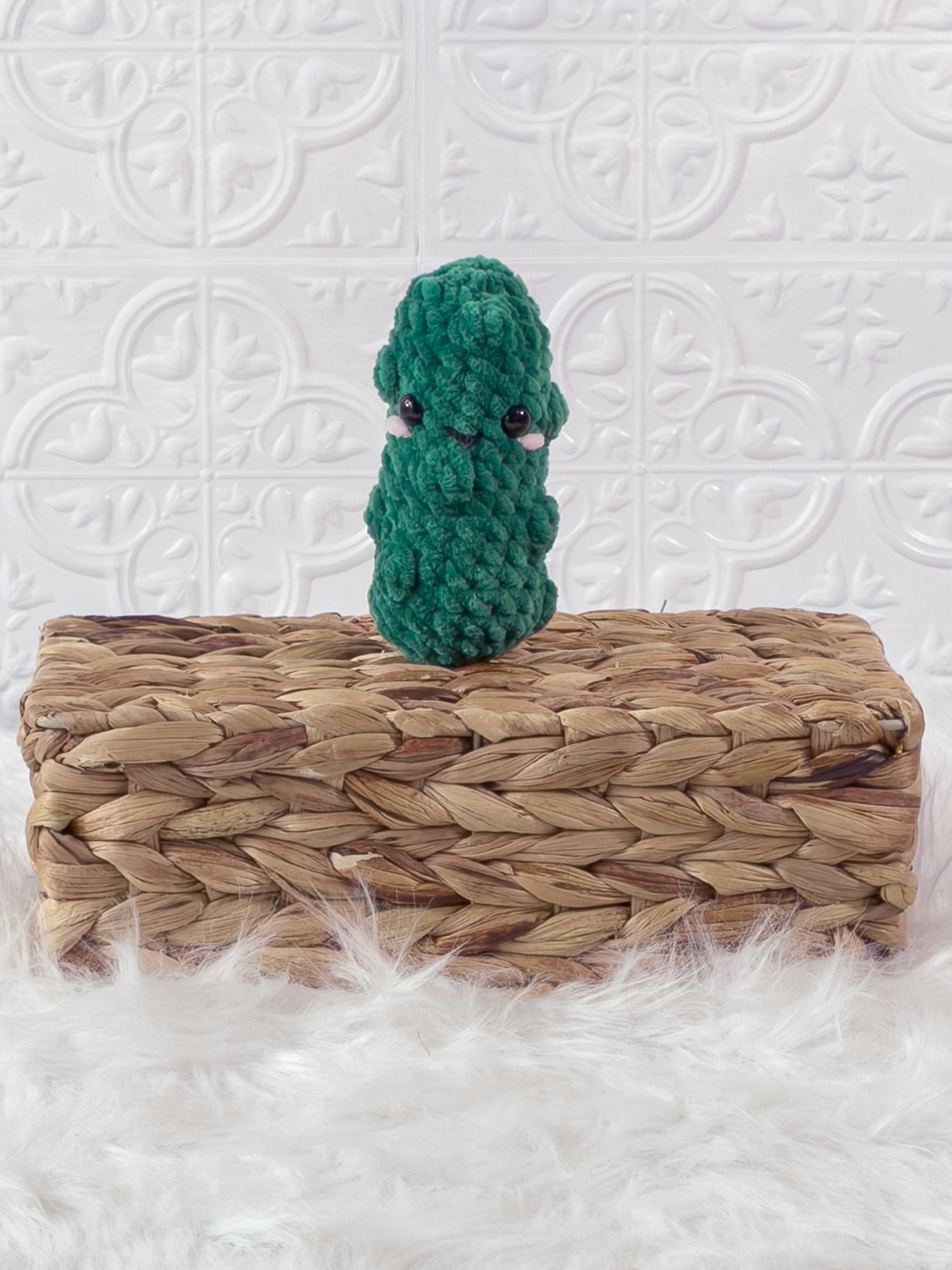 Handmade green, dark dill pickle crochet plushie shown from the front