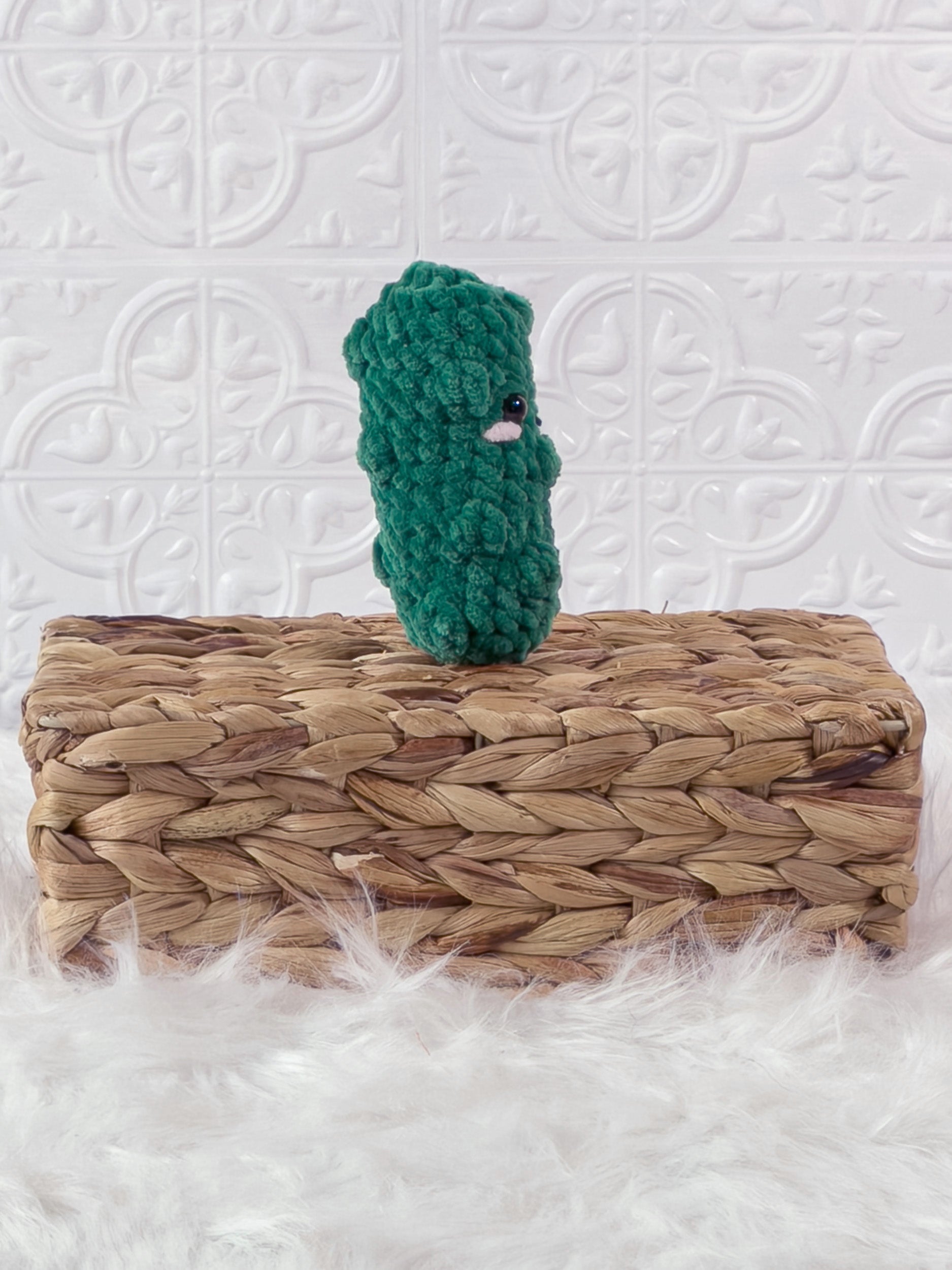 Handmade green, dark dill pickle crochet plushie shown from the side