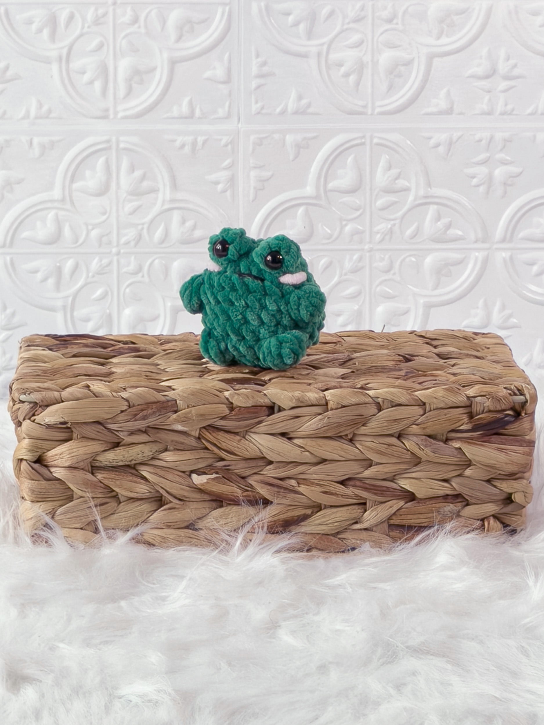 Small handmade frog crochet plushie shown from the front