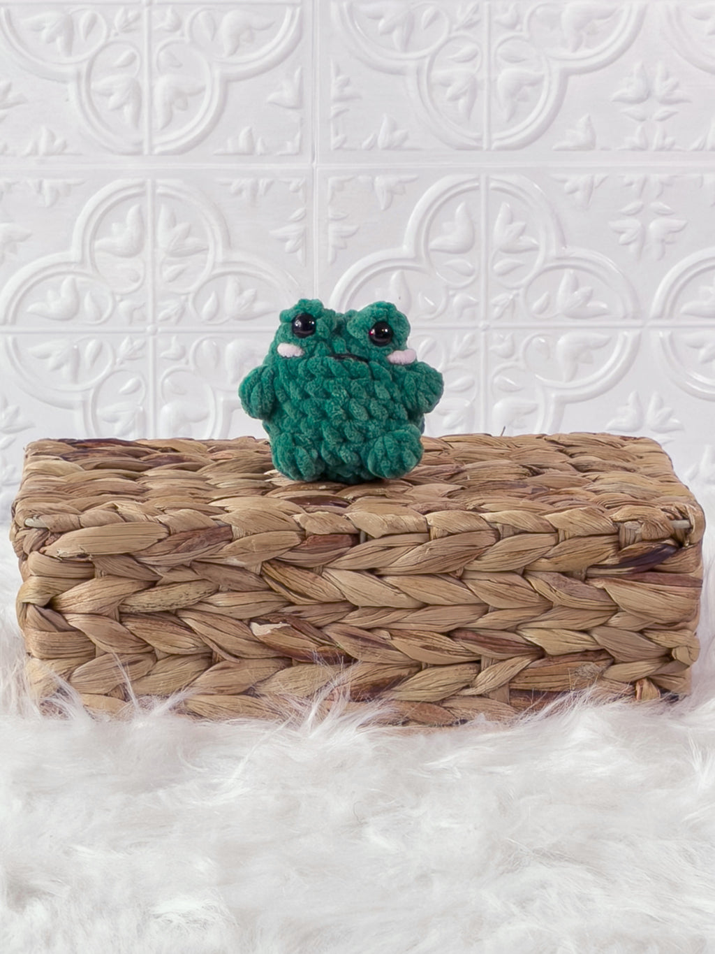 Handmade green, dark mini frog crochet plushie shown from the front