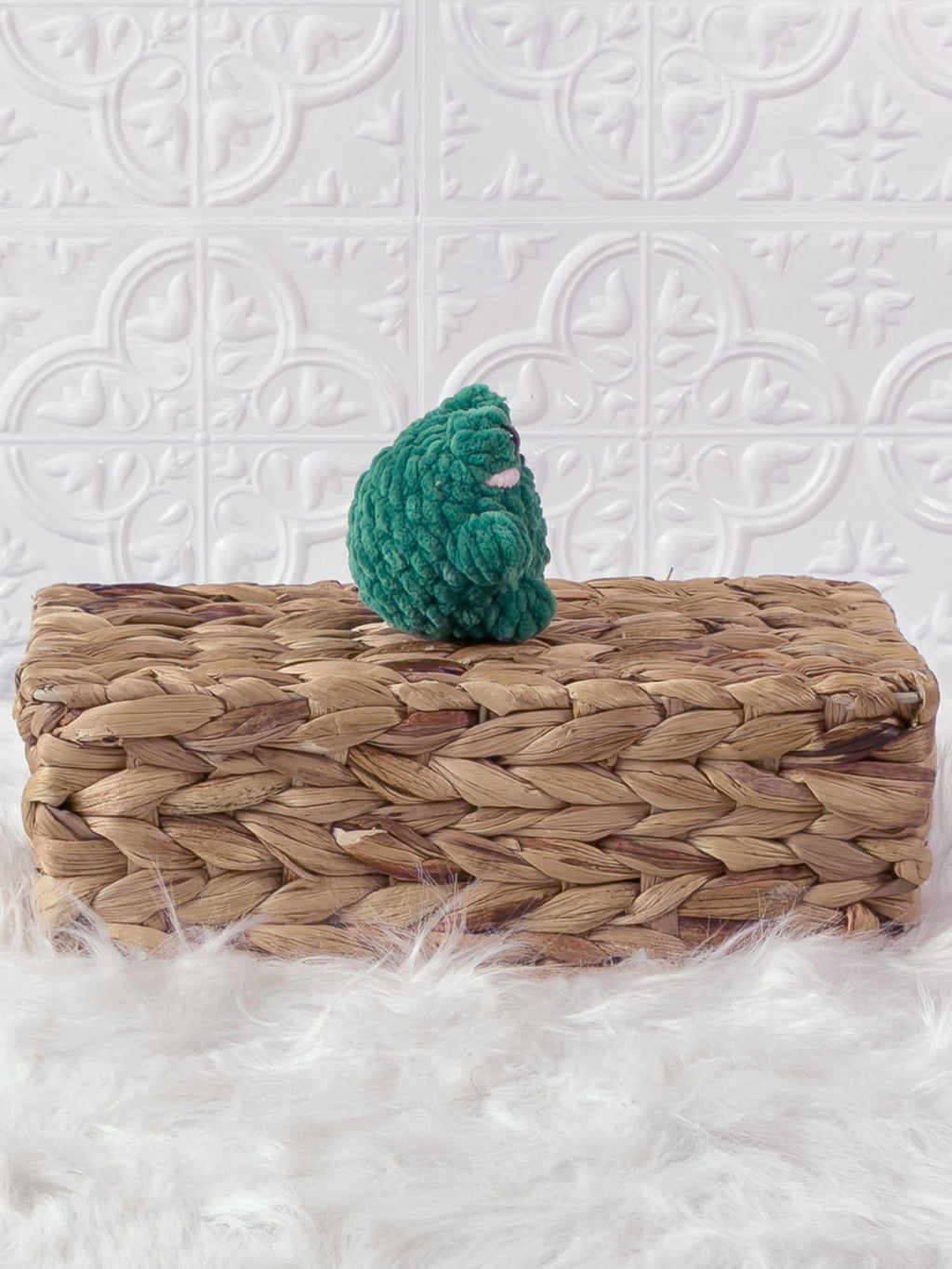 Handmade green, dark mini frog crochet plushie shown from the side