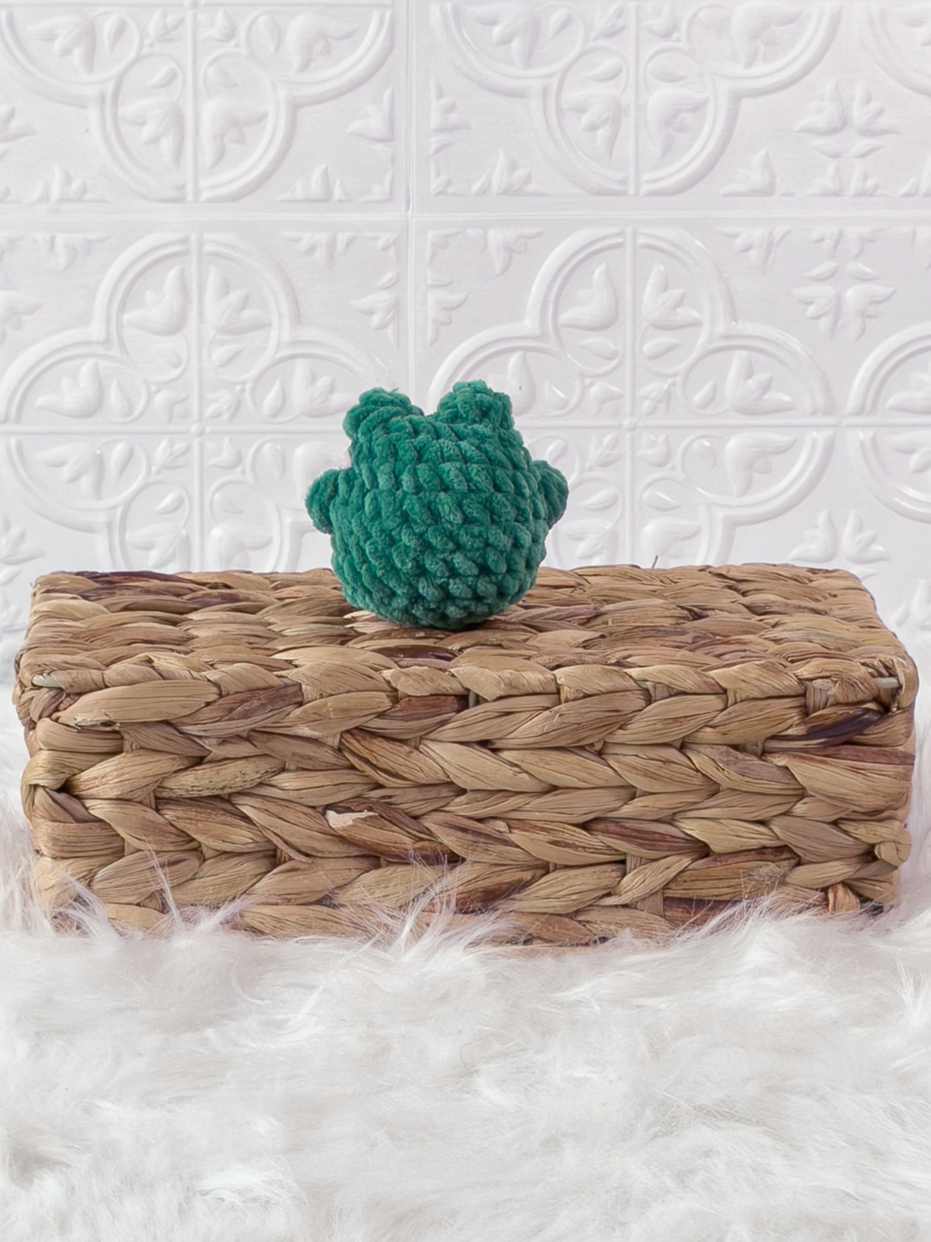 Handmade green, dark mini frog crochet plushie shown from the back