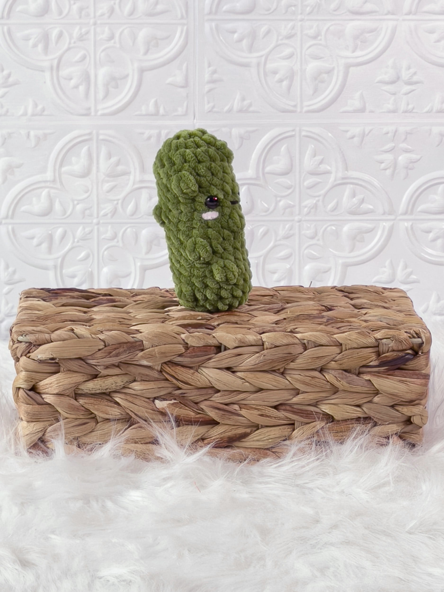 Handmade green, light dill pickle crochet plushie shown from an angled view