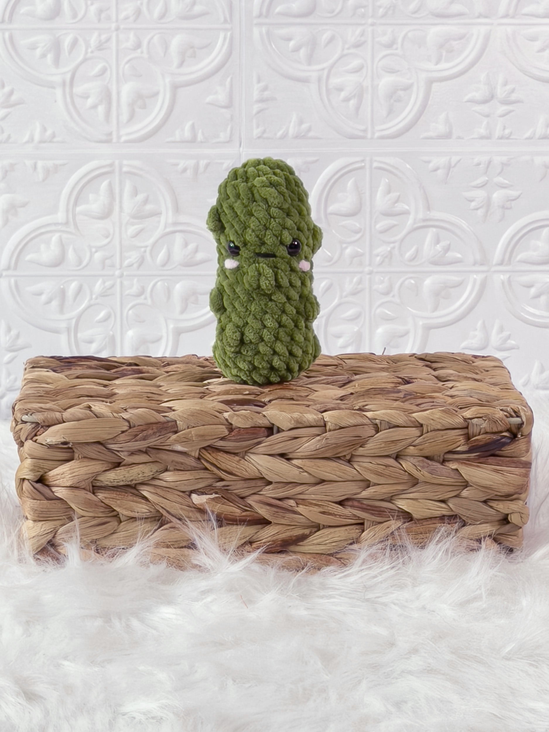 Handmade green, light dill pickle crochet plushie shown from the front