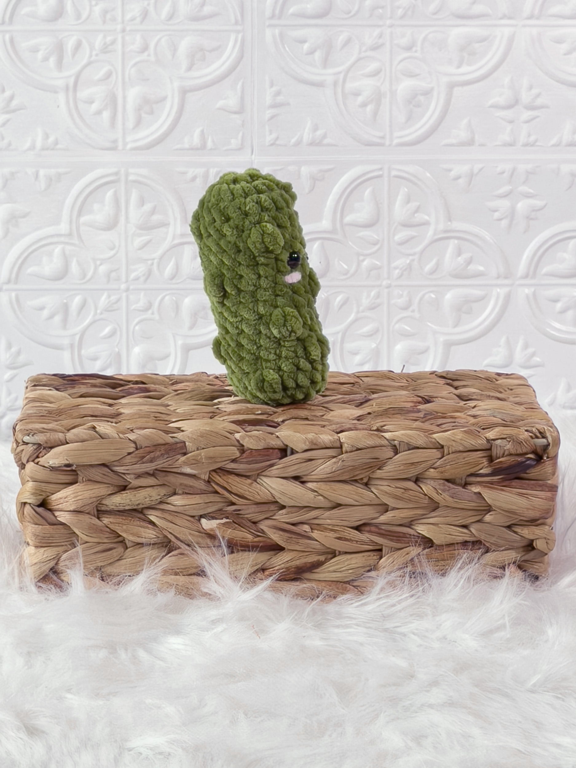 Handmade green, light dill pickle crochet plushie shown from the side