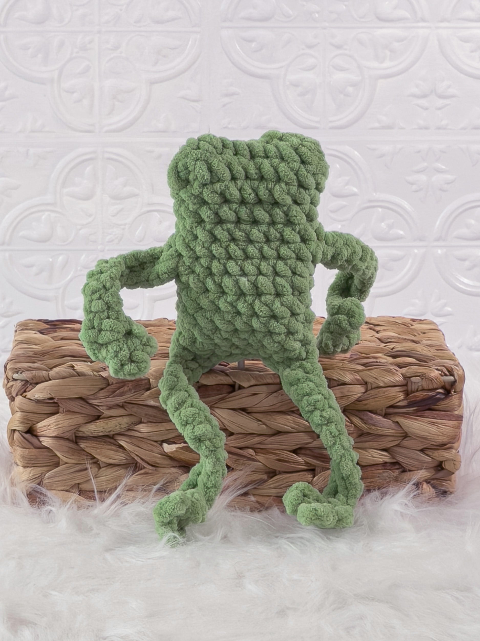Handmade green, light leggy froggy crochet plushie shown from the back
