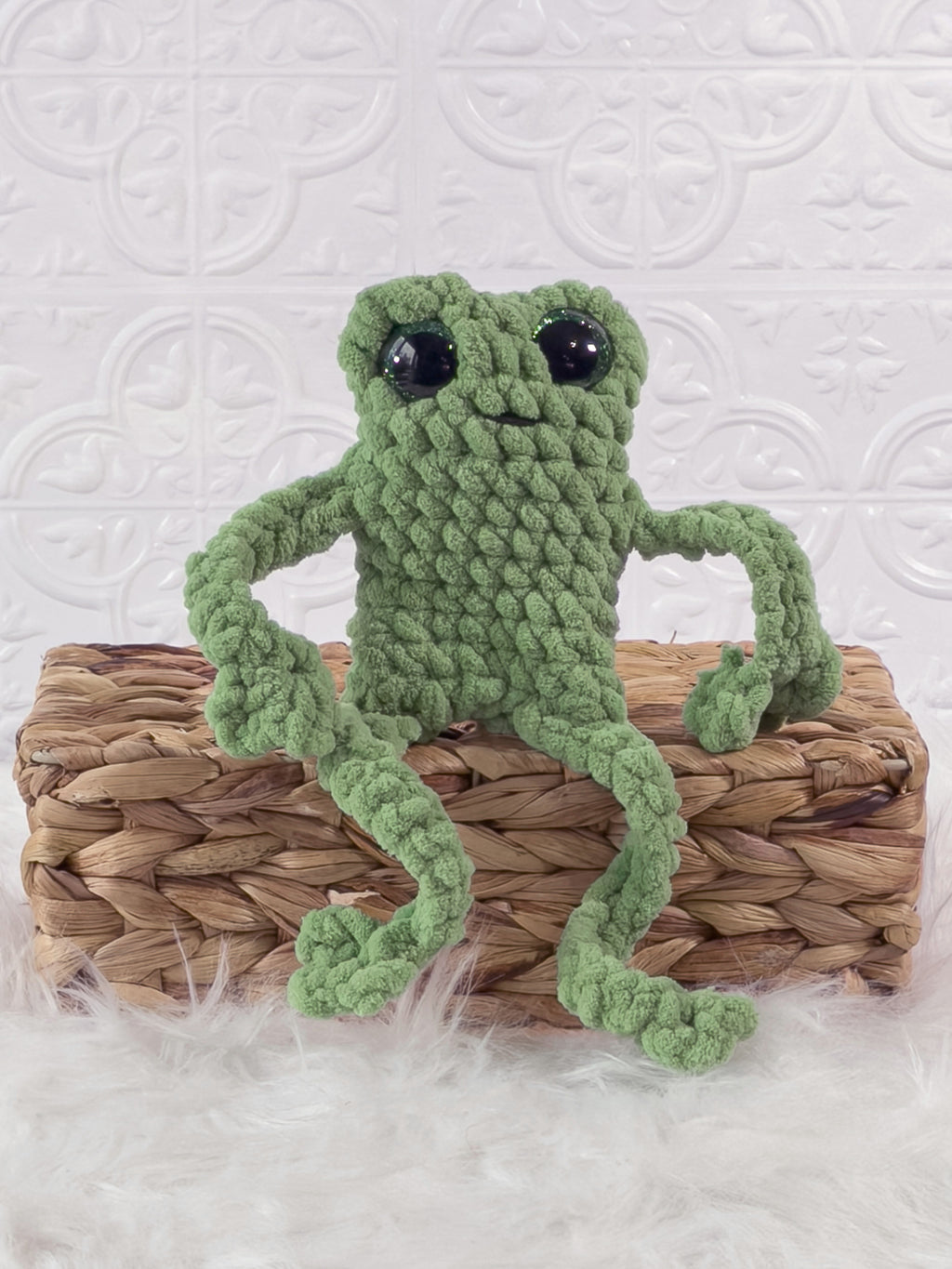 Handmade green, light leggy froggy crochet plushie shown from the front