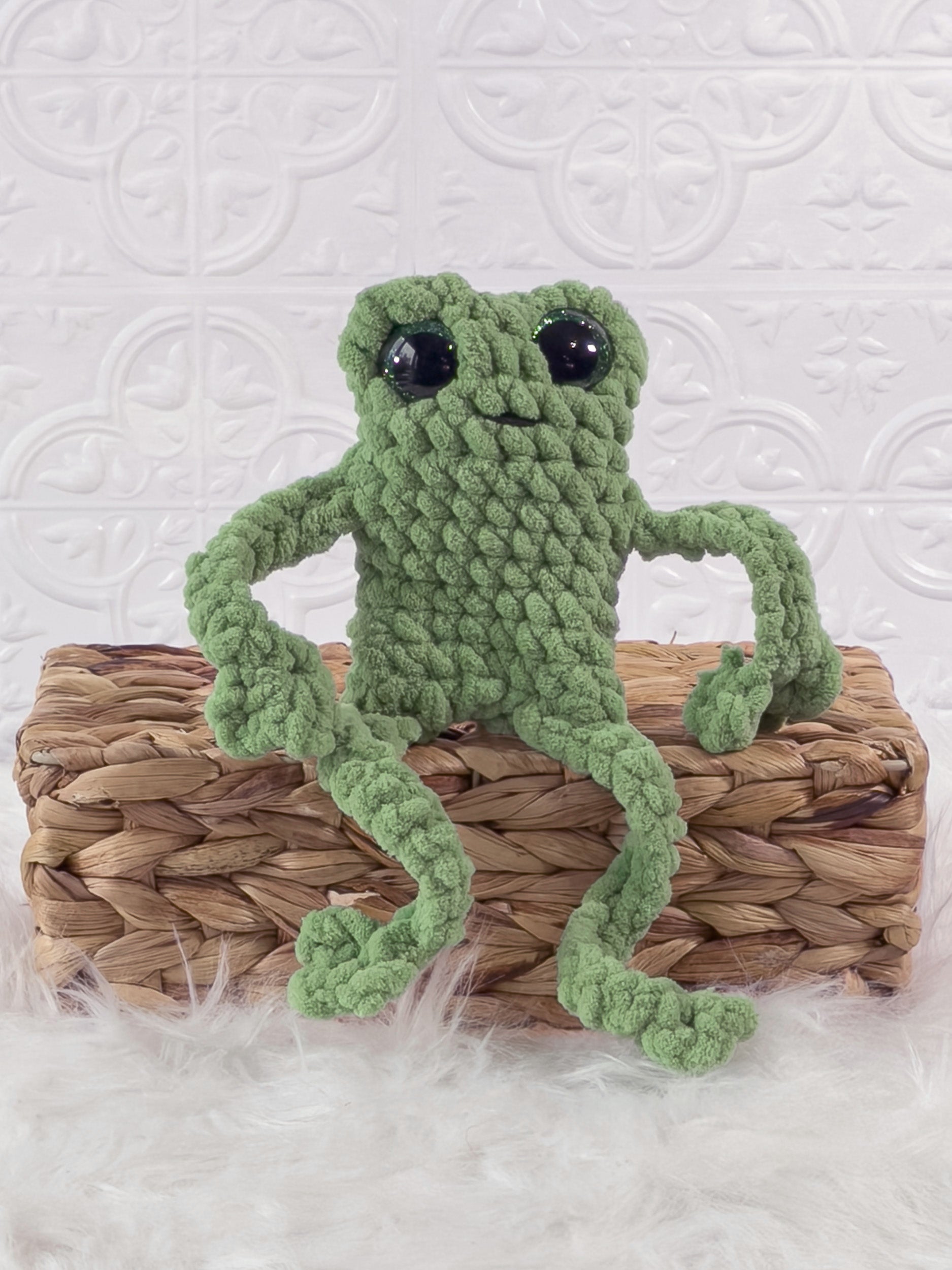 Handmade green, light leggy froggy crochet plushie shown from the front