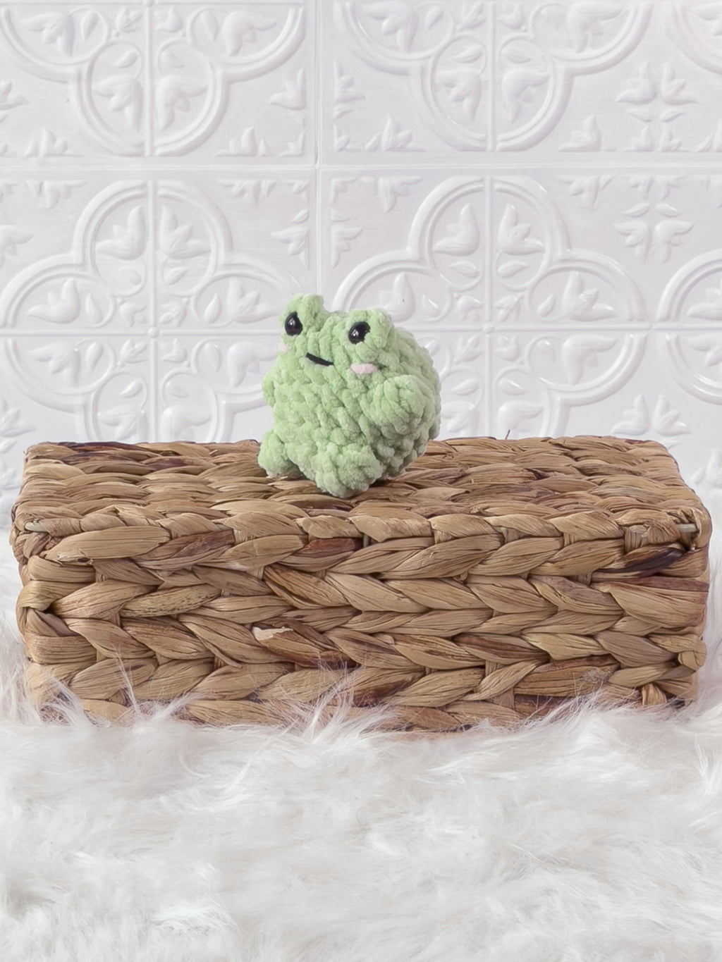 Small handmade frog crochet plushie shown from the front