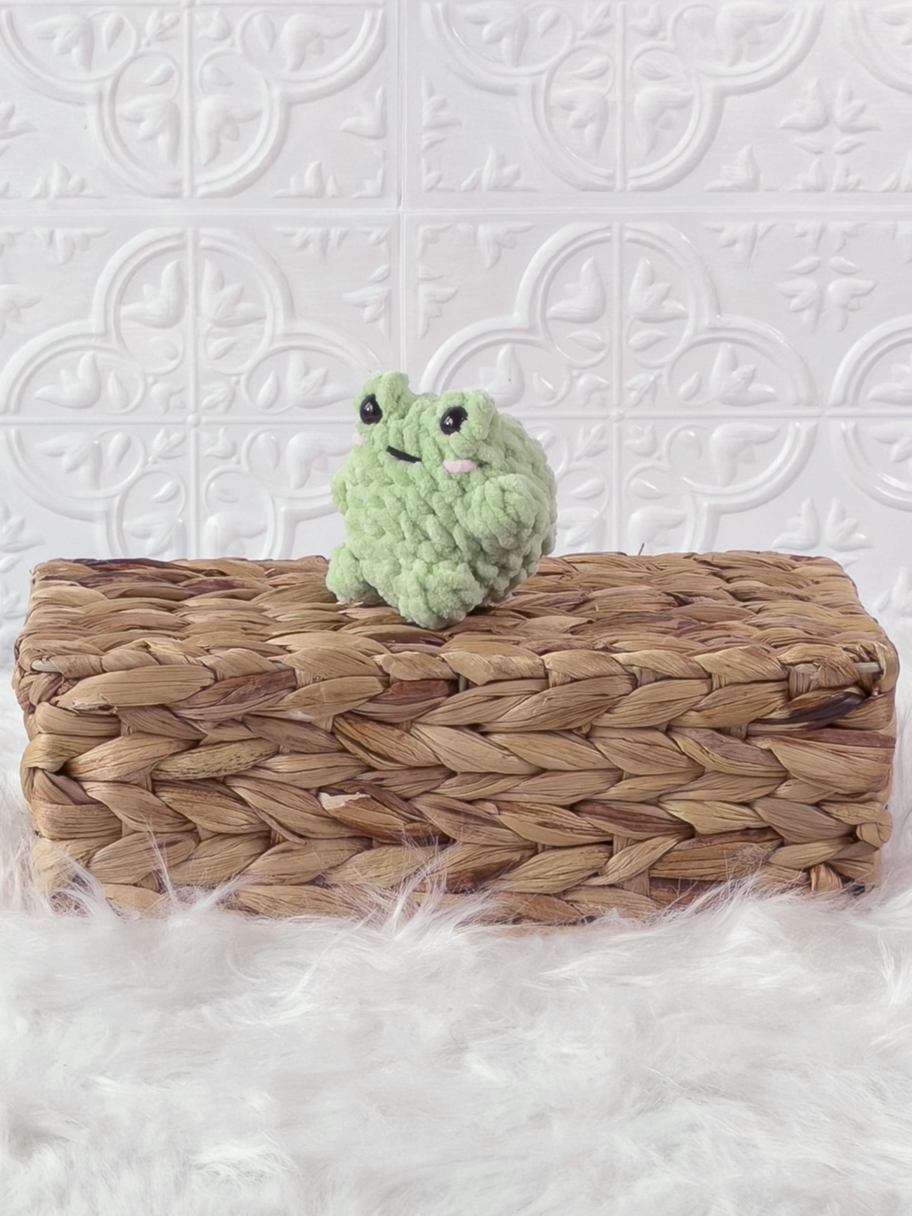 Small handmade frog crochet plushie shown from the front