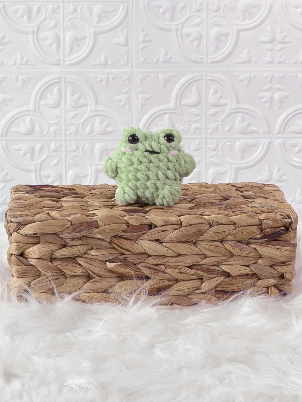 Handmade green, light mini frog crochet plushie shown from the front