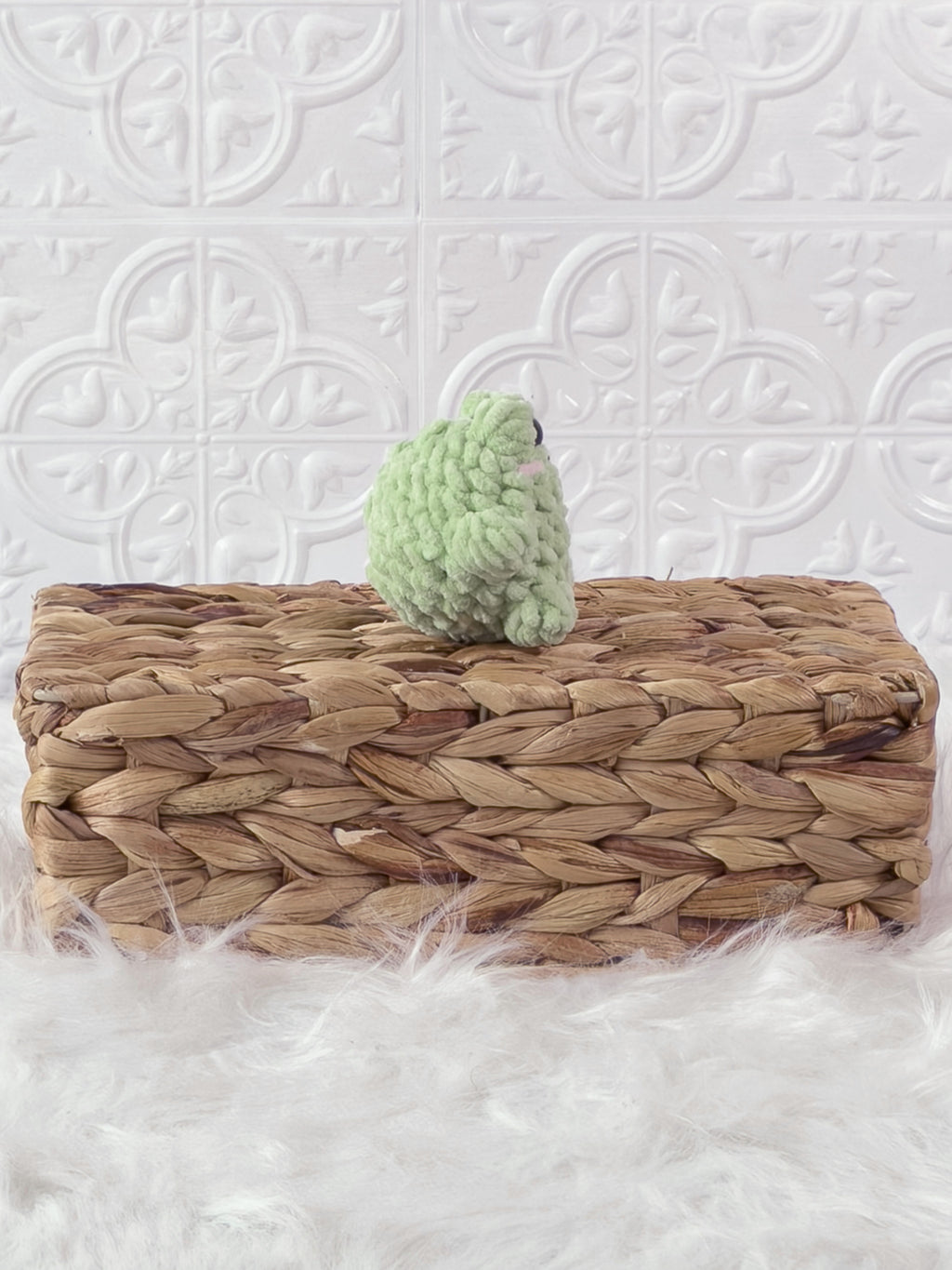 Handmade green, light mini frog crochet plushie shown from the side