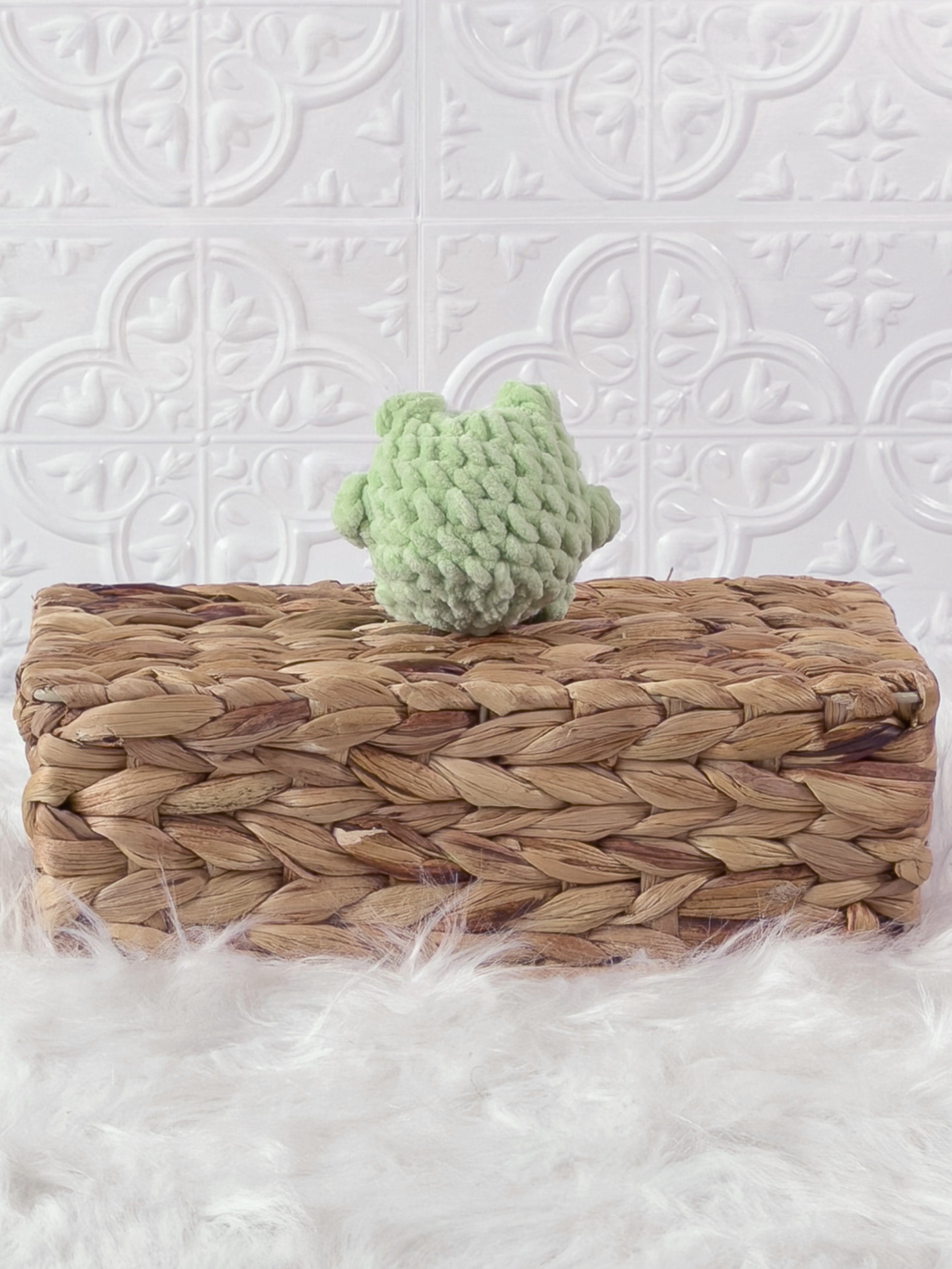 Handmade green, light mini frog crochet plushie shown from the back