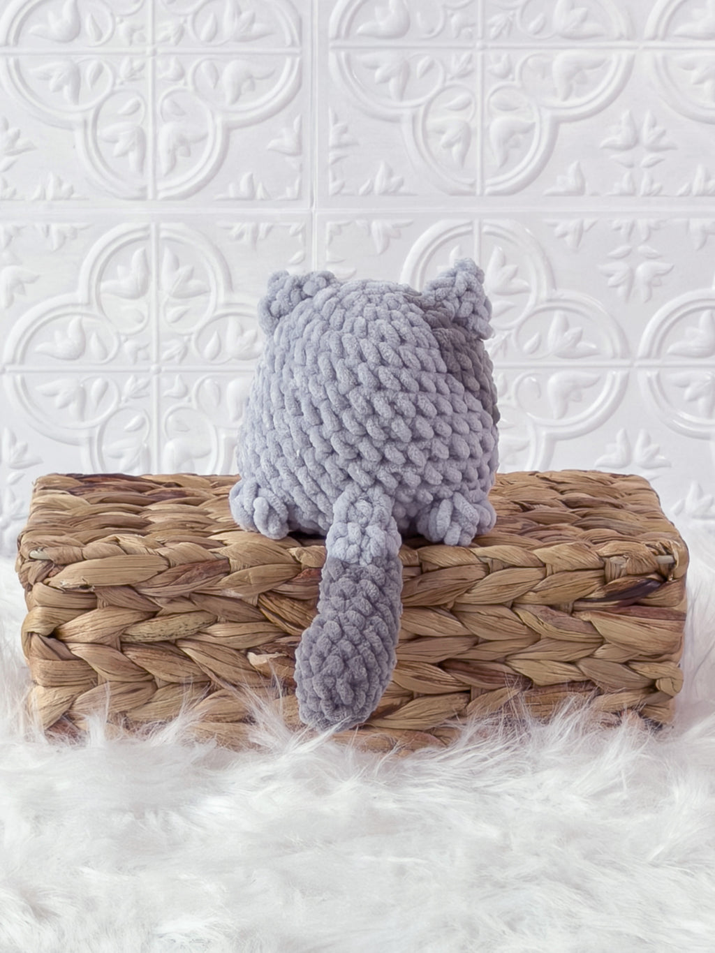Handmade grey kitten crochet plushie shown from the back
