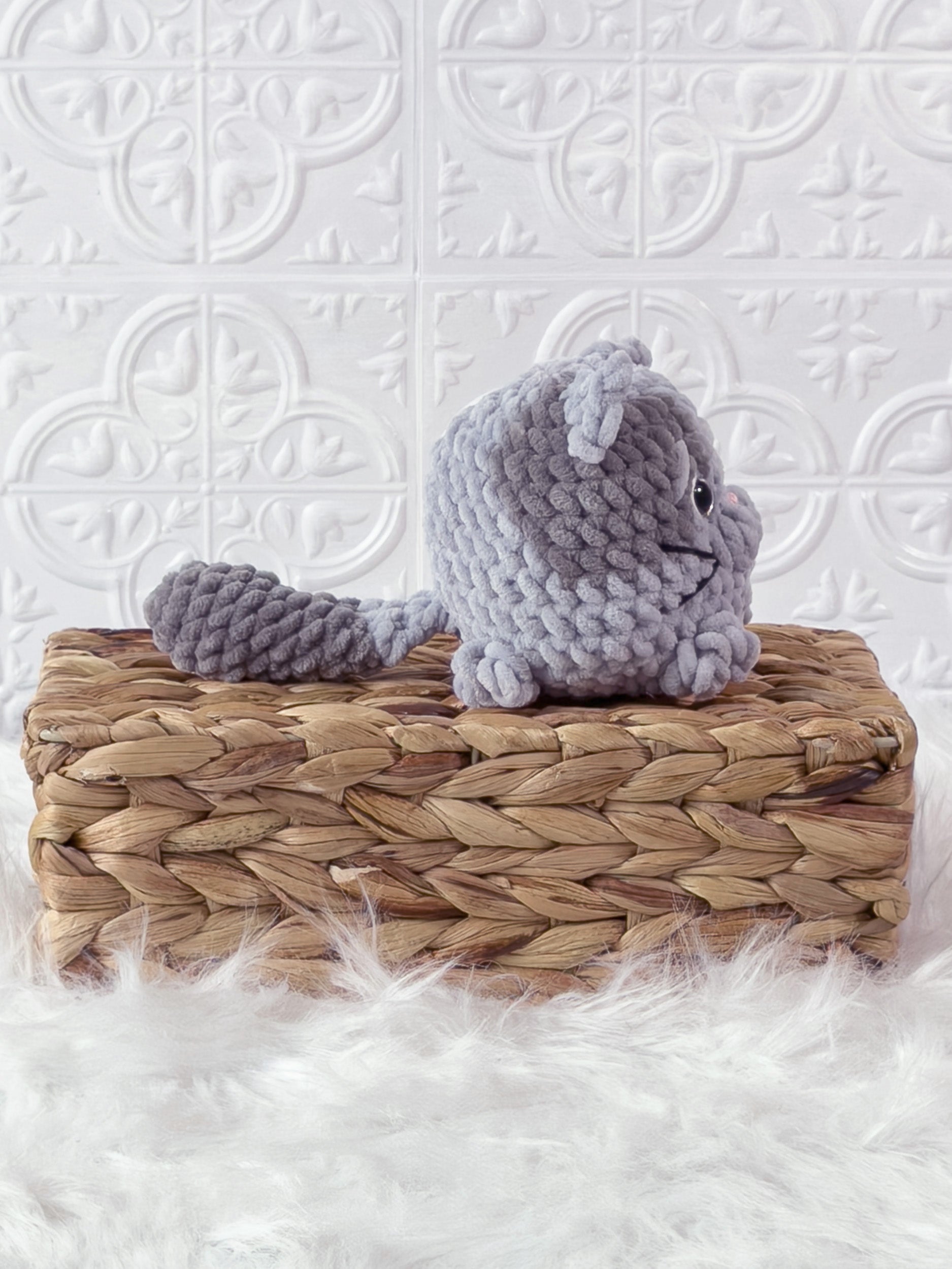 Handmade grey kitten crochet plushie shown from the side